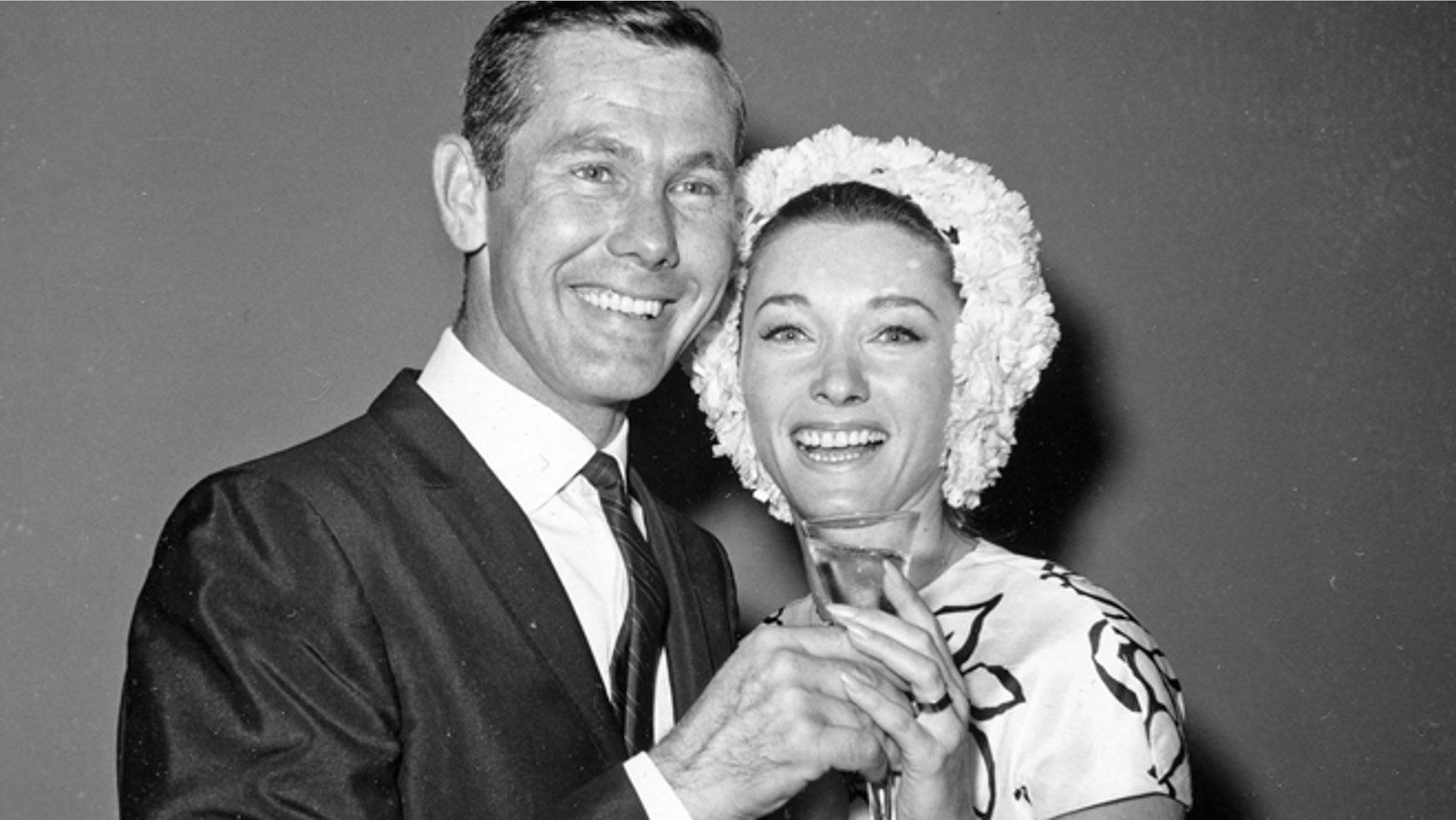 This Aug. 17, 1963 file photo shows comedian Johnny Carson and his bride, former television personality and model Joanne Copeland, at a reception in his apartment after their wedding at in New York.