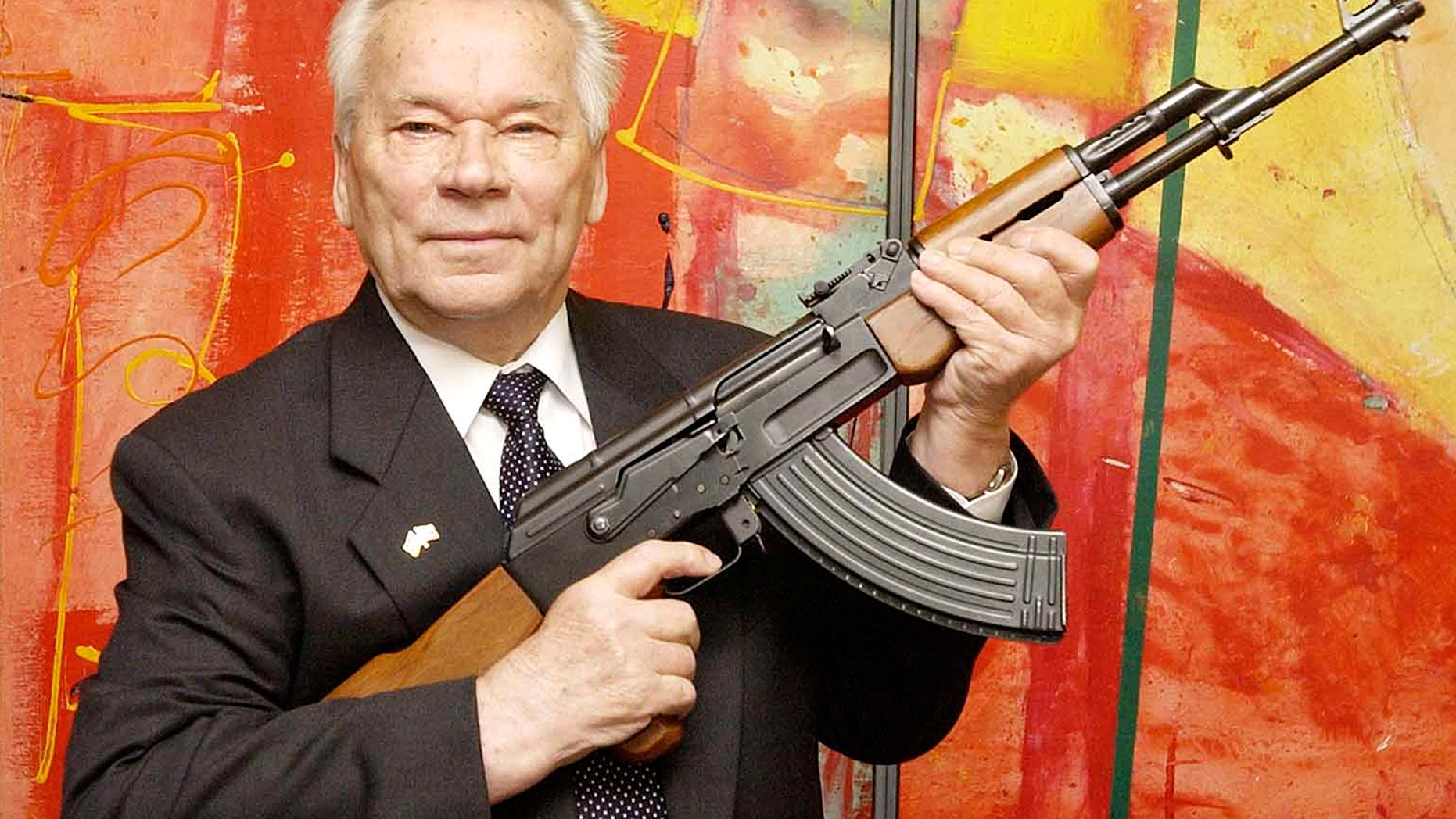 July 26, 2002 - FILE photo of Russian weapon designer Mikhail Kalashnikov presenting his legendary assault rifle to the media while opening the exhibition "Kalashnikov - legend and curse of a weapon" at a weapons museum in Suhl, Germany. Kalashnikov died at the age of 94.