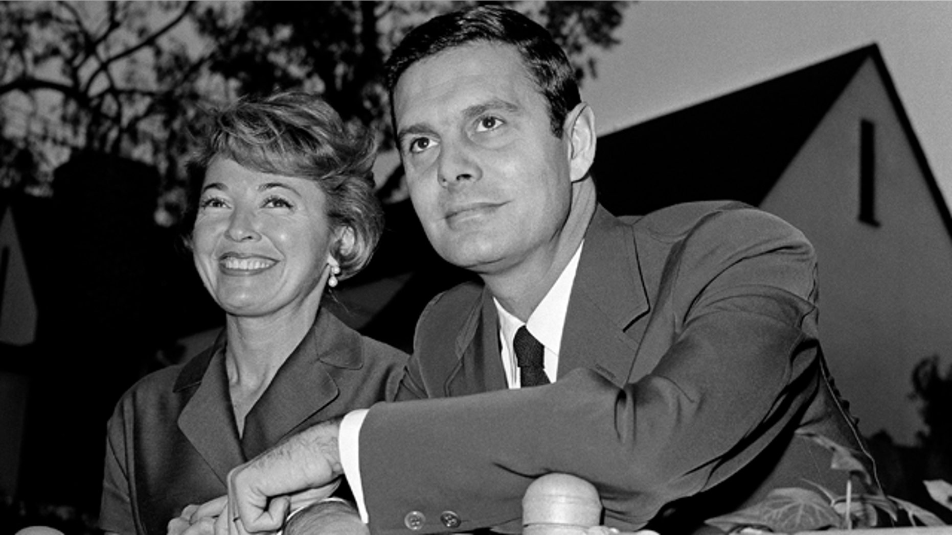 In this Jan. 5, 1959 file photo, actor Louis Jourdan and his wife Berthe Fredrique pose at their home in Beverly Hills, Calif. Jourdan, the dashingly handsome Frenchman who starred in "Gigi," ''Can-Can," ''Three Coins in the Fountain" and other American movies, has died on Saturday, Feb. 14, 2015. He was 93. (AP Photo, File)