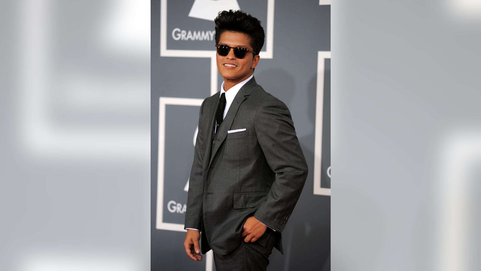 FILE - In this Feb. 12, 2012 file photo, Bruno Mars arrives at the 54th annual Grammy Awards in Los Angeles. The mother of Grammy-winning pop star Bruno Mars has died. Bernadette Hernandez died Saturday, June 1, 2013 of a brain aneurysm, according to a publicist for Mars' label, Atlantic Records, who spoke to The Associated Press on condition of anonymity because the person was not authorized to speak on the record.(AP Photo/Chris Pizzello, File)