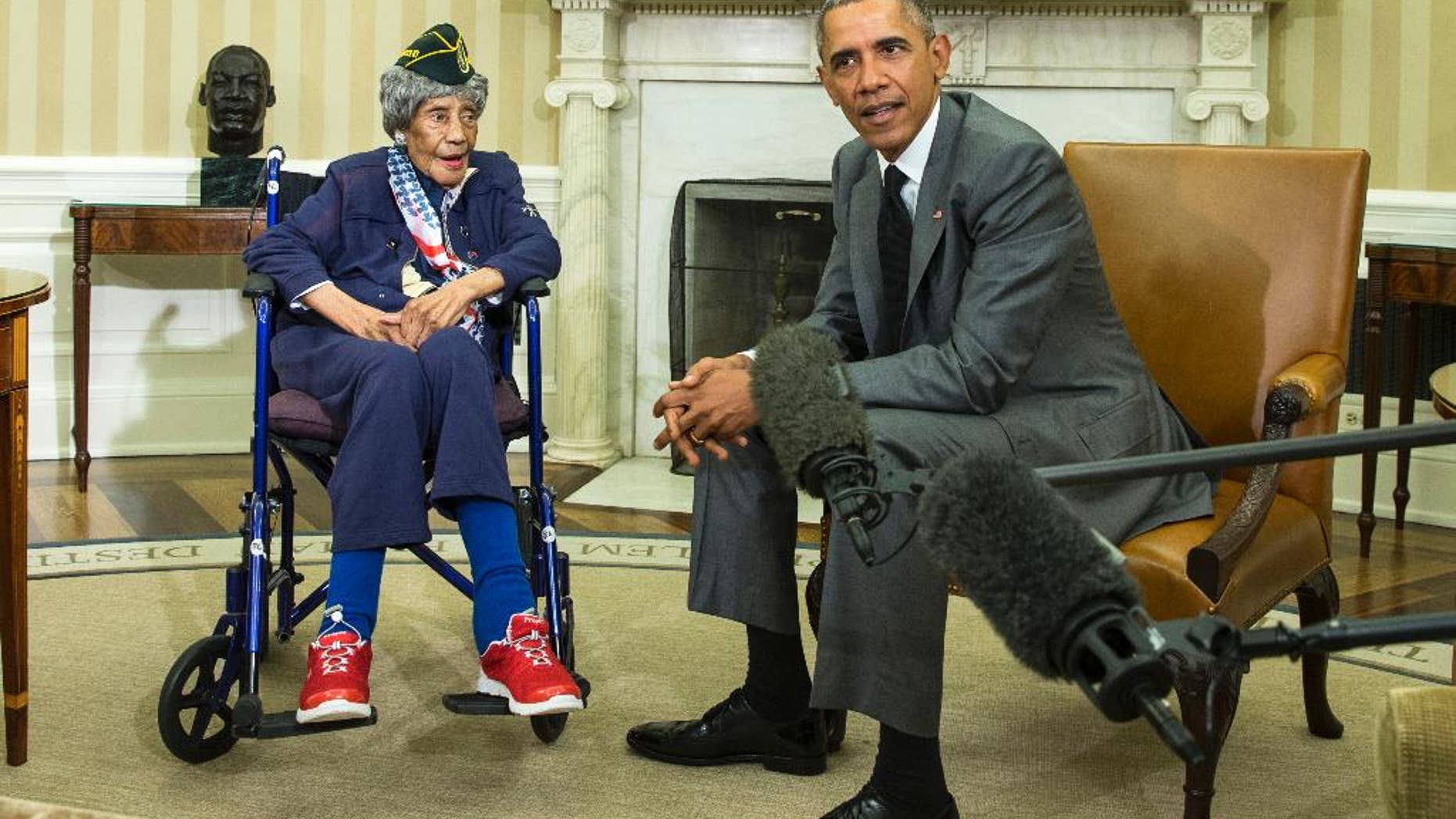 FILE - In this July 17, 2015, file photo, President Barack Obama meets with Emma Didlake, 110, of Detroit, the oldest known World War II veteran, in the Oval Office of the White House in Washington. The Michigan woman who was believed to be the nation's oldest veteran has died a month after meeting the president. The Oakland County medical examiner's office says Didlake died Sunday, Aug. 16 in West Bloomfield, northwest of Detroit. (AP Photo/Evan Vucci, File)