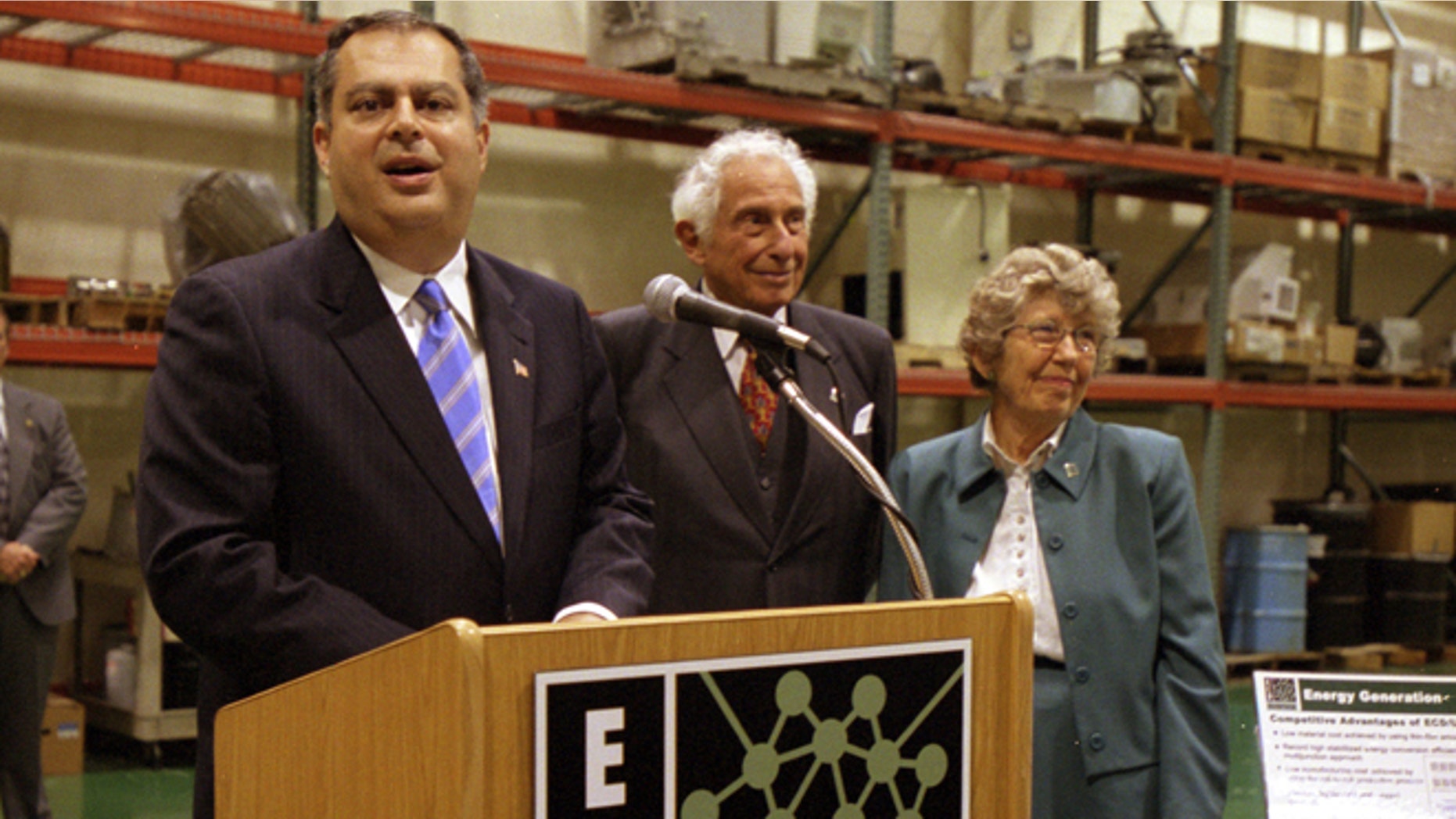 FILE - This Aug. 23, 2002 file photo shows Stanford Ovshinsky, center, co-founder of Energy Conversion Devices Inc. with his wife Iris, right, appeared with U.S. Secretary of Energy Spencer Abraham at a news conference at the companys offices in Rochester Hills, Mich., on Aug. 23, 2002. Stan Ovshinsky, 89, died Wednesday, Oct. 17, 2012, at his home in Bloomfield Hills from complications of prostate cancer. (AP Photo/Kathleen Wayt, file)
