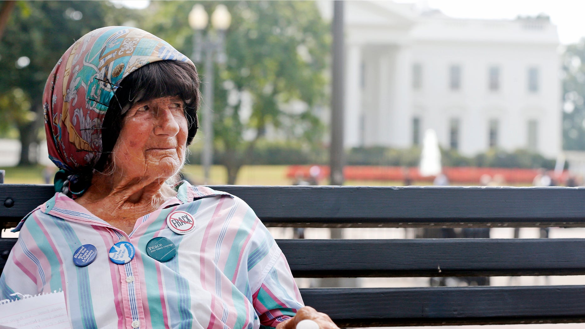 FILE - In this Sept. 12, 2013 file photo, Concepcion Picciotto, who holds a constant peace vigil in Lafayette Park across from the White House in Washington, sits on a park bench in the park. Picciotto, the protester who maintained a peace vigil outside the White House for more than three decades, a demonstration widely considered to be the longest-running act of political protest in U.S. history, has died. The Washington Post reports Picciotto died Monday, Jan. 25, 2016, at a housing facility for homeless women. She was believed to be 80. (AP Photo/Charles Dharapak, File)