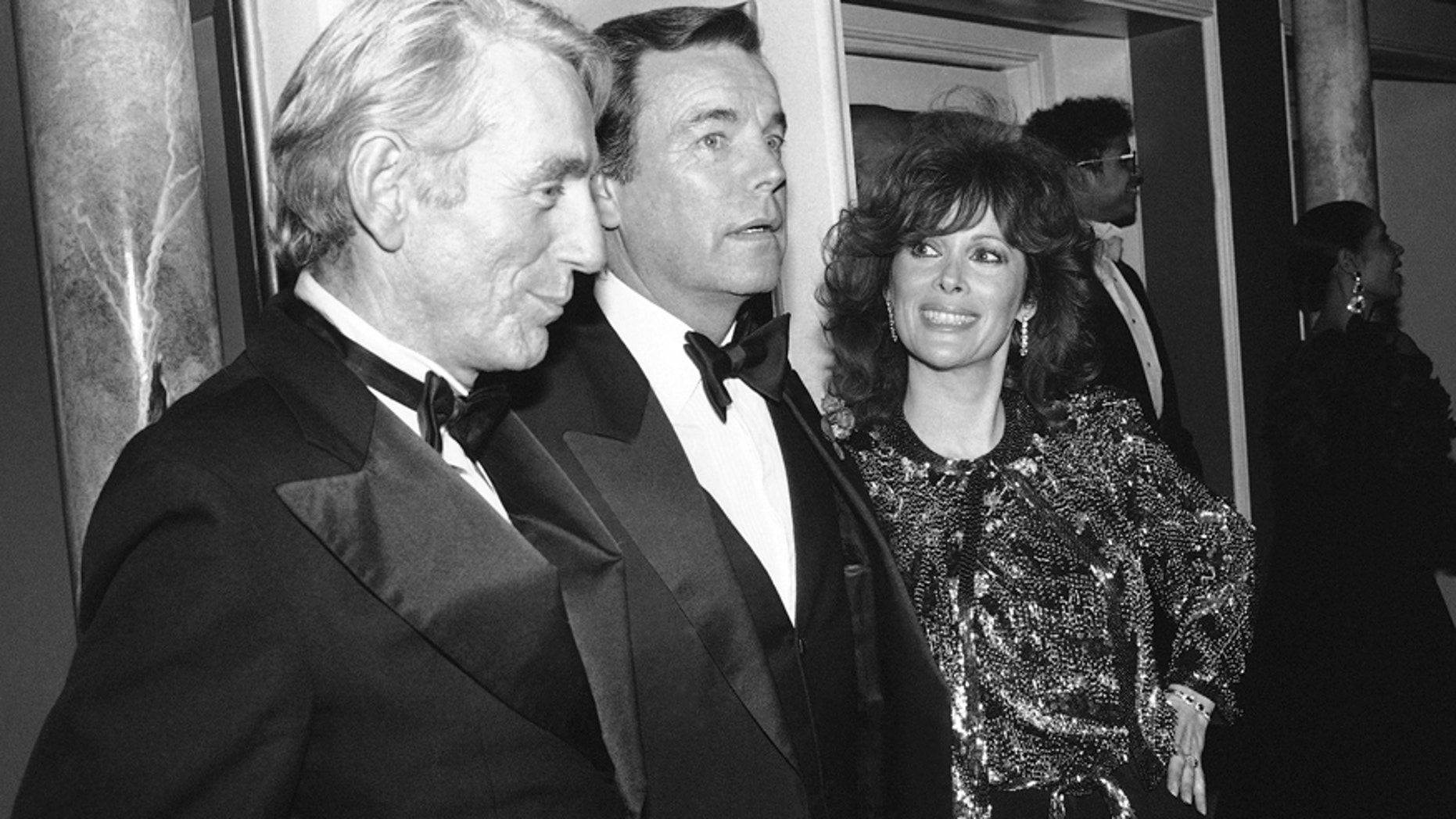 FILE - In this Feb. 18, 1985 file photo, Jill St. John, right, with Robert Wagner, center, and Rod McKuen, left, attend a party for "Night of 100 Stars II," in New York. McKuen, the husky-voiced "King of Kitsch" whose music and verse recordings won him an Oscar nomination and made him one of the best-selling poets in history, has died on Thursday, Jan. 29, 2015. He was 81.