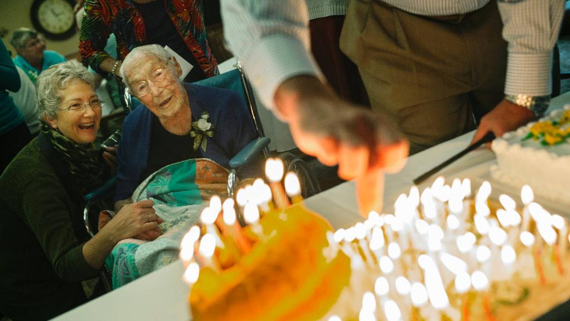 This Oct. 12, 2014 photo shows Anna Stoehr, center, celebrating her 114th birthday at Green Prairie Place senior apartments in Plainview, Minn. Stoehr, one of Minnesota's oldest residents, died Sunday, Dec. 20, 2014 in her sleep after several days in hospice care, according to her son, Harlan Stoehr. (AP Photo/The Star Tribune, Richard Tsong-Taatarii) ST. PAUL PIONEER PRESS OUT, MINNEAPOLIS-AREA TV OUT, MAGS OUT