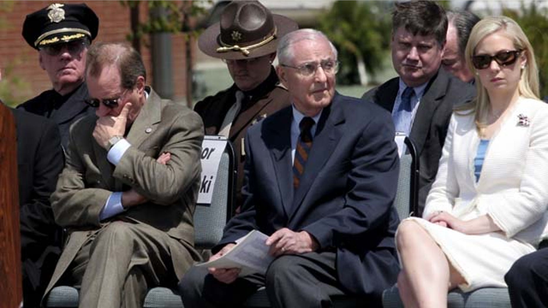 FILE - In this May 11, 2006, file photo, attending dignitaries including Oregon Gov. Ted Kulongoski, left, former Gov. Vic Atiyeh, center, and 2002 Miss America Katie Harmon sit, as the names of officers killed in the line of duty are read during the Oregon Law Enforcement Memorial ceremony at the new public-safety academy grounds in Salem, Ore. (AP Photo/Statesman-Journal, Thomas Patterson, File)