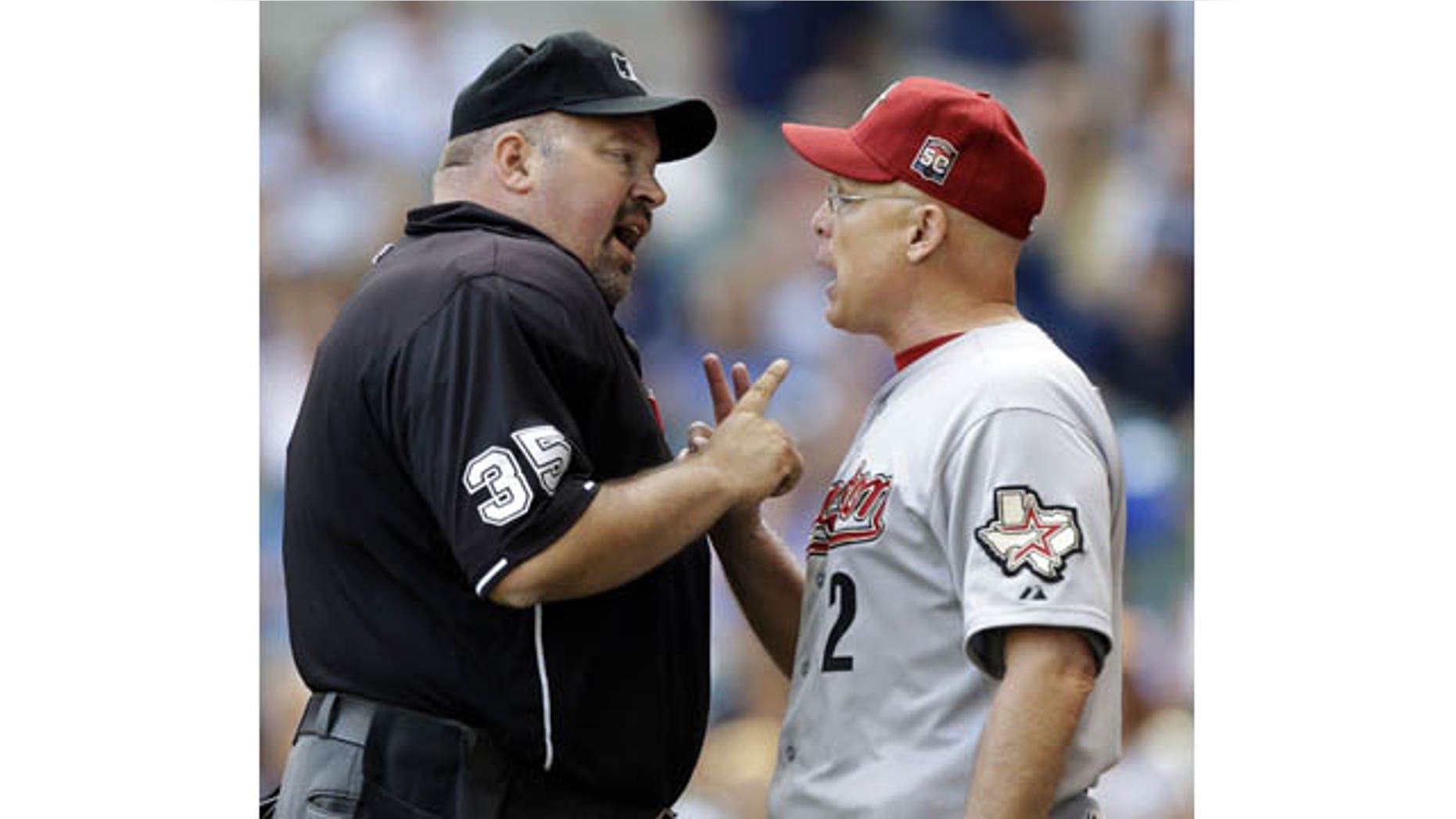 File-This Aug. 1, 2012 file photo shows Houston Astros manager Brad Mills, right, arguing with home plate umpire Wally Bell during the eighth inning of a baseball game against the Milwaukee Brewers in Milwaukee. (AP Photo)