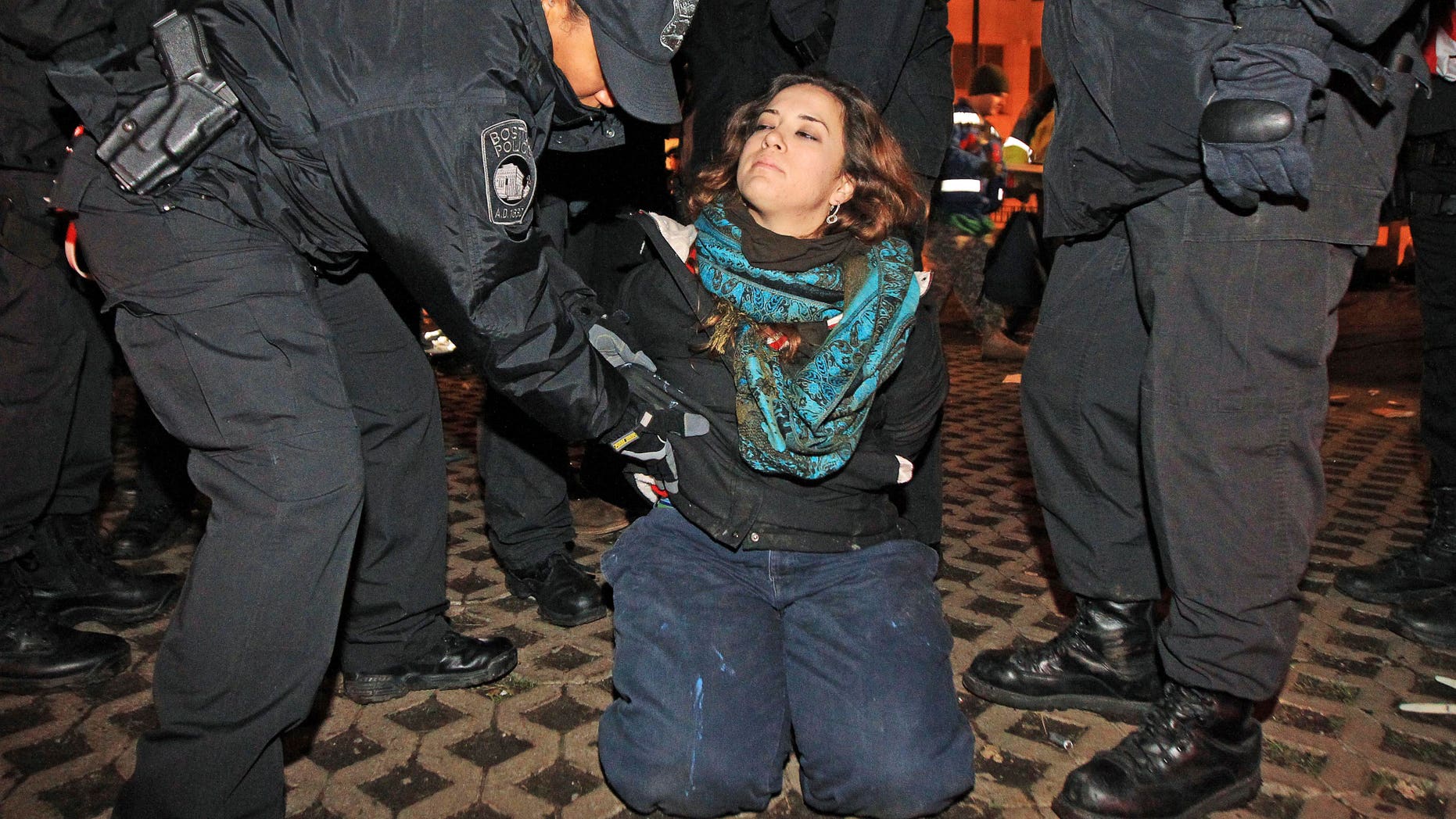 Dec. 10, 2011: Boston police officers remove an Occupy Boston protester from Dewey Square in Boston before dawn Saturday.
