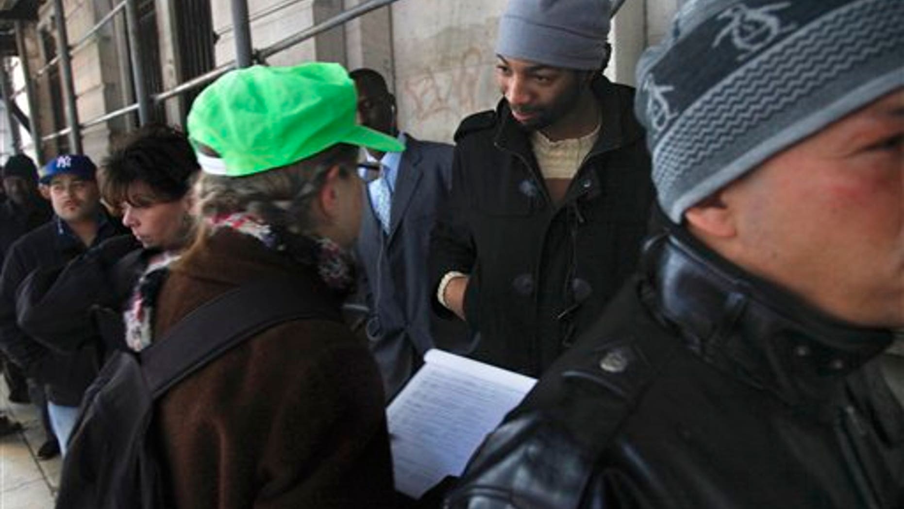 Dec. 14: Hero Vincent, second from right, an early protester in the Occupy Wall Street movement, listens as Judith Anderson, a lawyer working with the National Lawyers Guild, records information about him as he stands in line outside Manhattan Criminal Court on Wednesday.