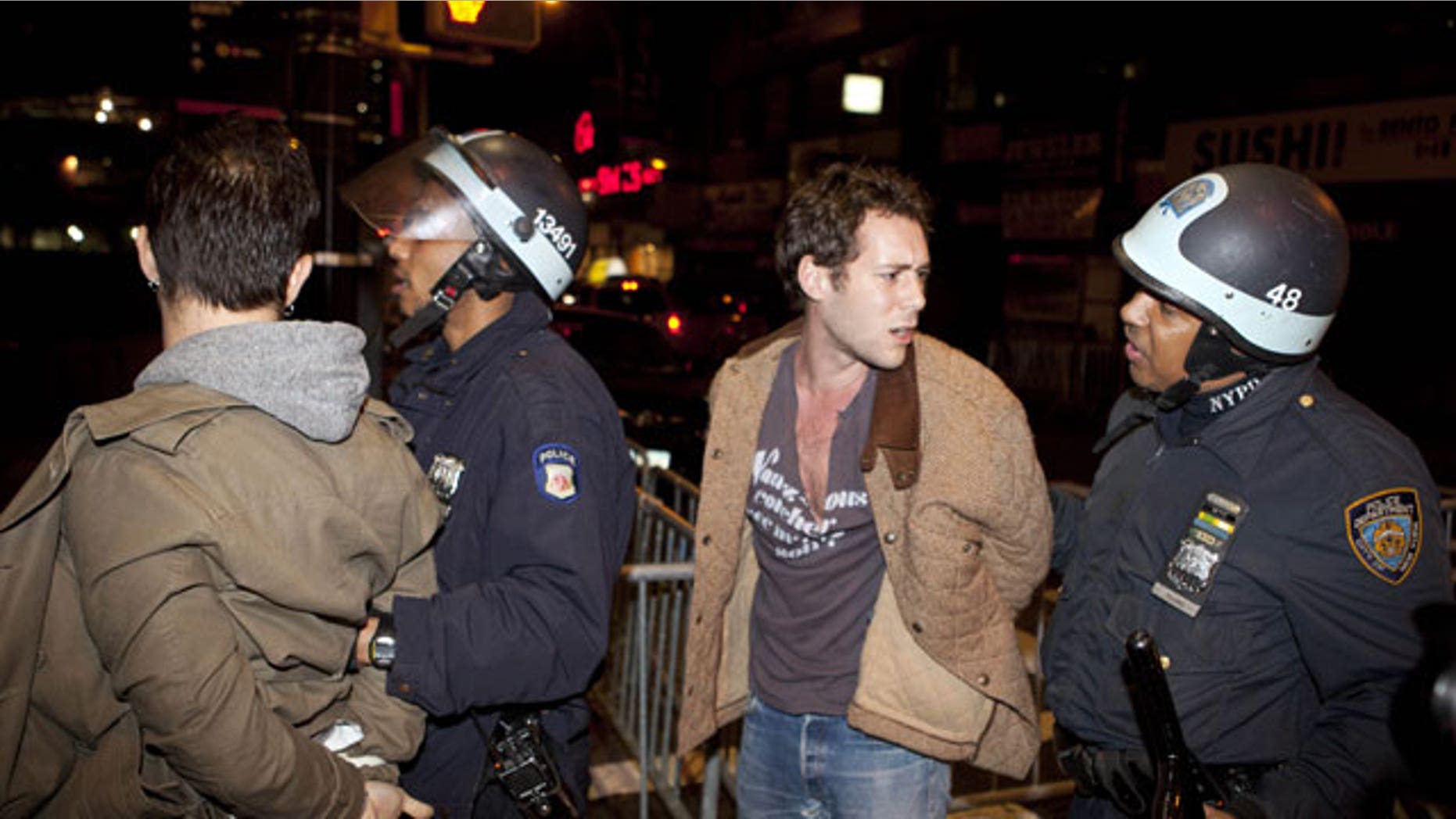 Nov. 15, 2011: Occupy Wall Street protesters are detained by police officers after being ordered to leave Zuccotti Park, their longtime encampment in New York.