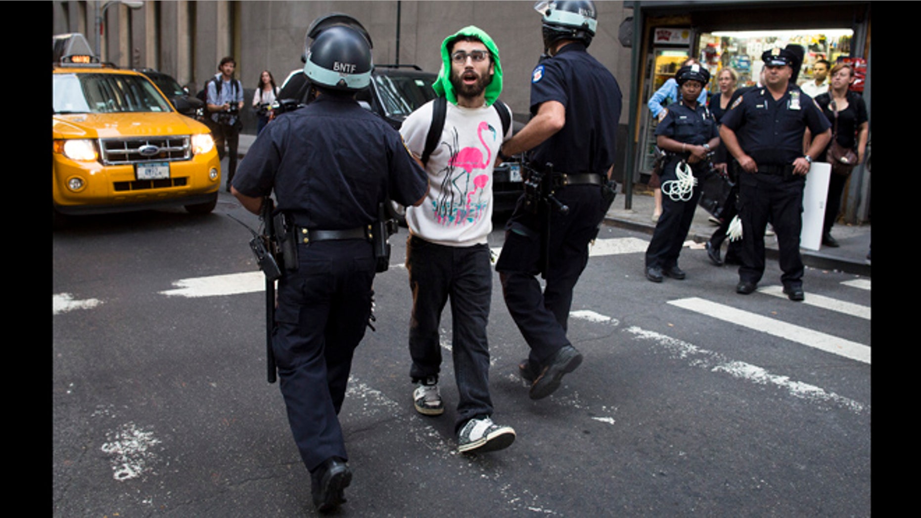 Sept. 17, 2012: An Occupy Wall Street protestor is arrested on Wall Street for blocking pedestrian traffic on a sidewalk in New York. A handful of Occupy Wall Street protestors have been arrested during a march toward the New York Stock Exchange on the anniversary of the grass-roots movement.
