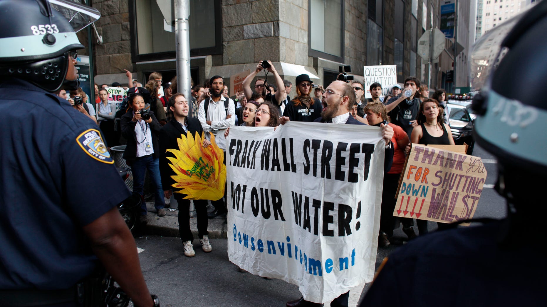 Protestors and police face off during an Occupy Wall Street march, Monday, Sept. 17, 2012, in New York. A handful of Occupy Wall Street protestors were arrested during a march on the New York Stock Exchange on the anniversary of the grass-roots movement. (AP Photo/Jason DeCrow)