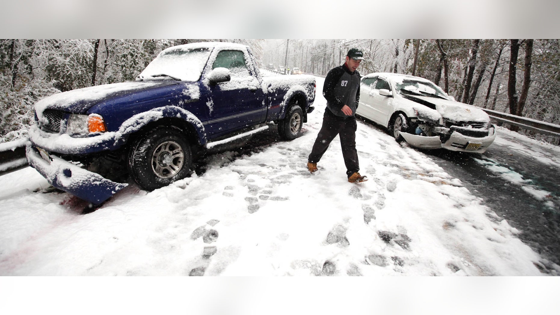 Due to wintry conditions, two cars were involved in a collision along Route 519 in Holland Township Saturday, Oct. 29, 2011 in Holland Township, N.J.. A heavy storm chugging along up the U.S. East Coast was expected to dump anywhere from a dusting of snow to about 10 inches (25 centimeters) throughout the region starting Saturday, a decidedly unseasonal date for a type of storm more associated with midwinter. (AP Photo/The Express-Times, Stephen Flood)