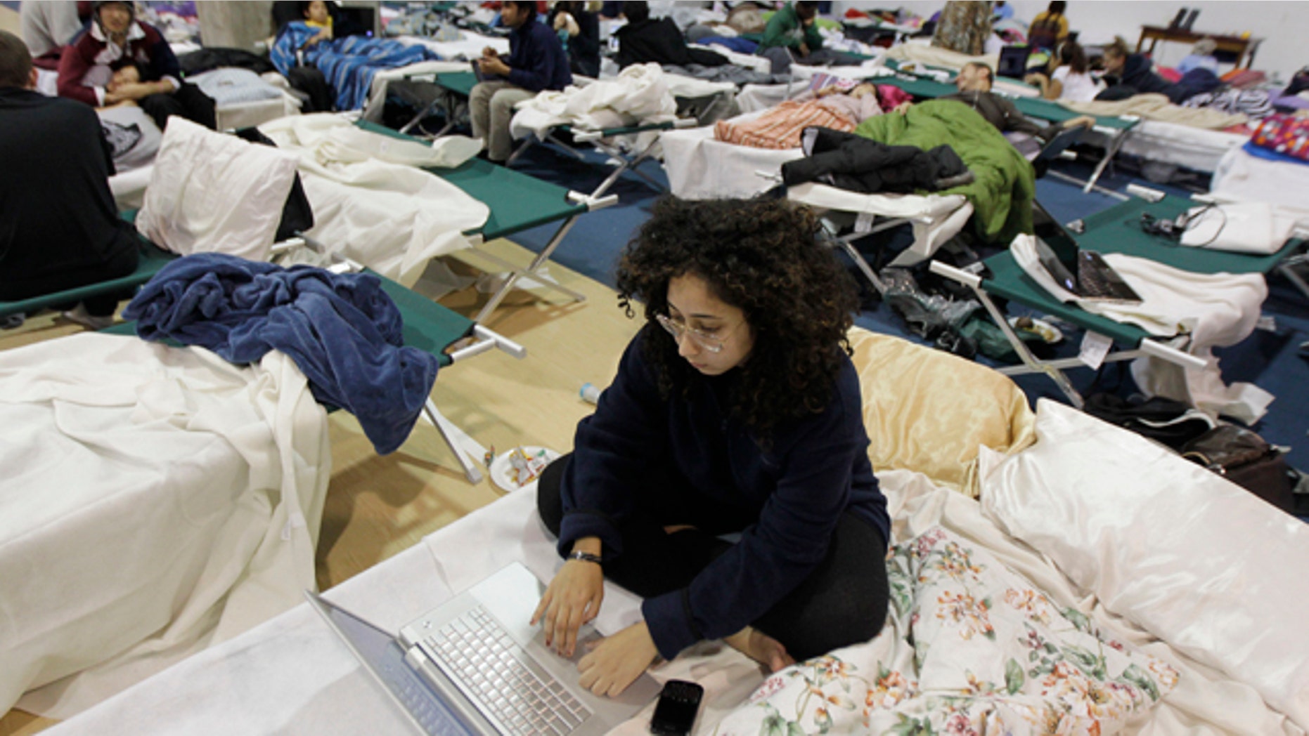 Oct. 31, 2011: Jasmine Sarryeh, an international student at Fairleigh Dickinson University, browses the internet while staying in a shelter at the school's gym following a rare October snowstorm.