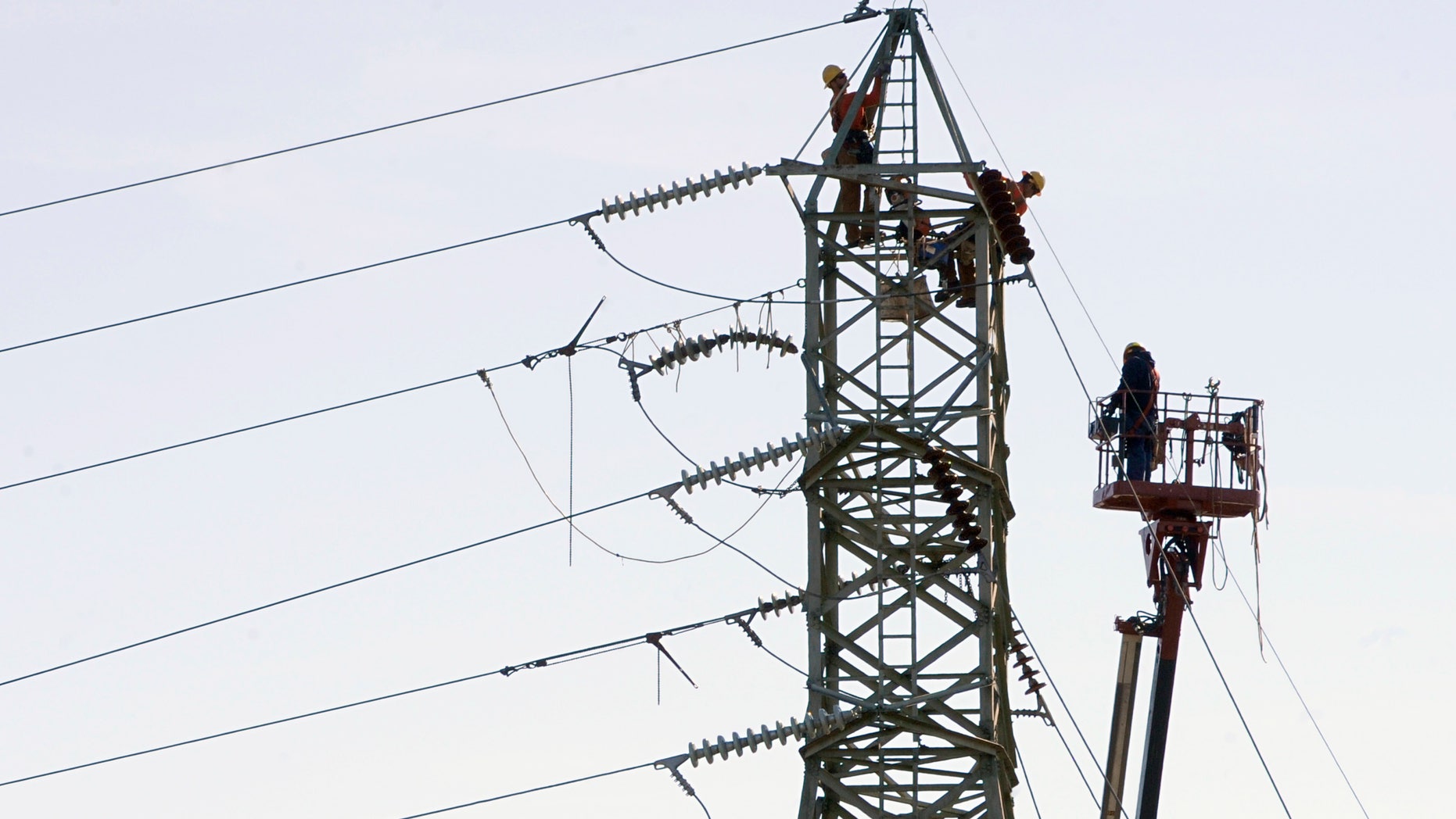 Connecticut Light & Power workers tend to a high voltage power line in Windsor Locks, Conn., Wednesday, Nov. 2, 2011. Over 90% of the town has been without power since the Oct. 29, 2011 snowstorm. (AP Photo/Jessica Hill)