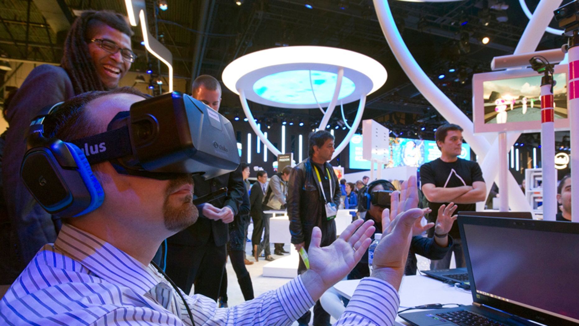 An attendee wearing an Oculus Rift virtual reality headset plays in a virtual volleyball game at the Intel booth during the 2015 International Consumer Electronics Show (CES) in Las Vegas, Nevada January 6, 2015.