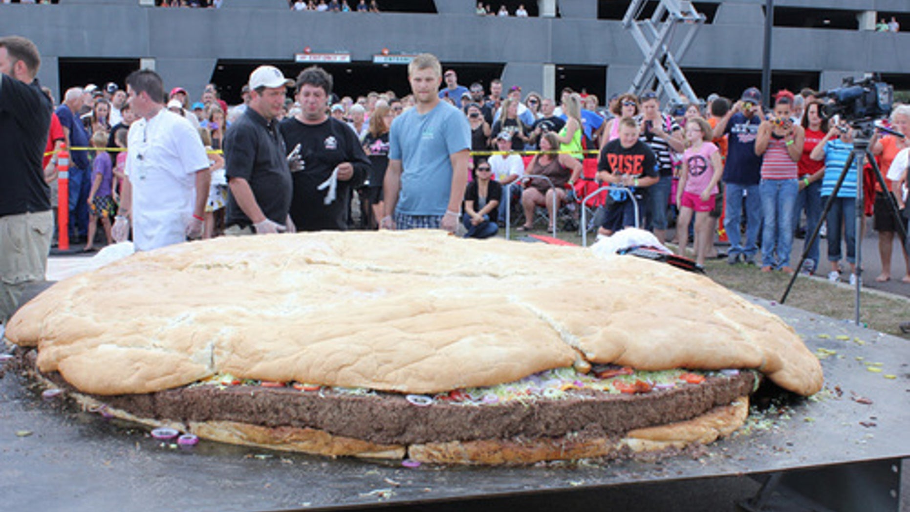 Sept. 2, 2012: People examine a bacon cheeseburger measuring 10 feet in diameter and weighing 2,014 pounds at Black Bear Casino Resort near Carlton, Minn.