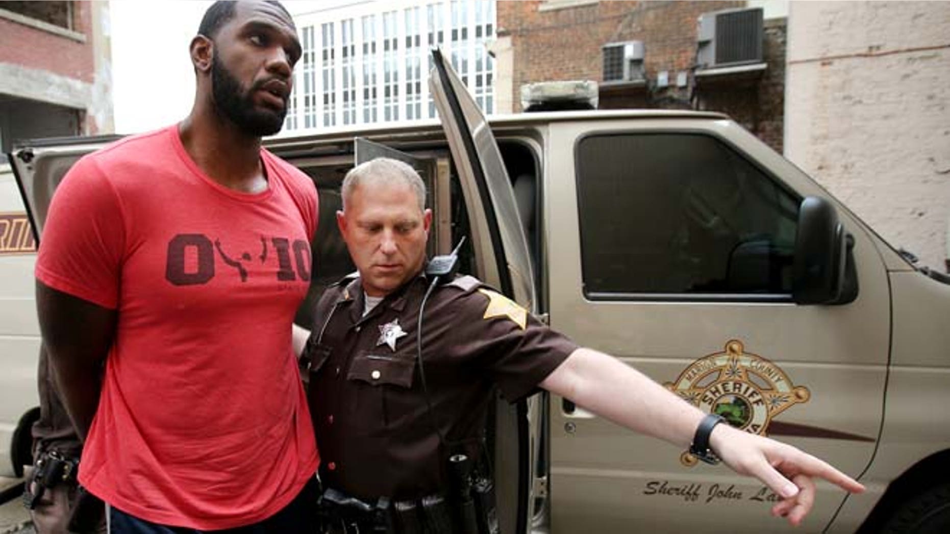 Aug. 7, 2014: Greg Oden is escorted into the Marion County Community Corrections building in Indianapolis. (AP/The Indianapolis Star)