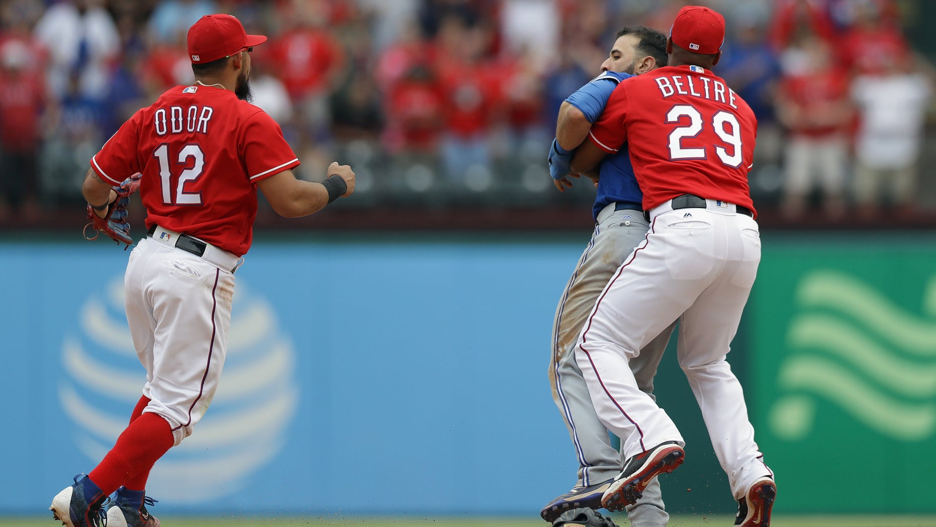 ARLINGTON, TX - MAY 15: Adrian Beltre #29 of the Texas Rangers holds Jose Bautista #19 of the Toronto Blue Jays after being punched by Rougned Odor #12 in the eighth inning at Globe Life Park in Arlington on May 15, 2016 in Arlington, Texas. (Photo by Ronald Martinez/Getty Images)