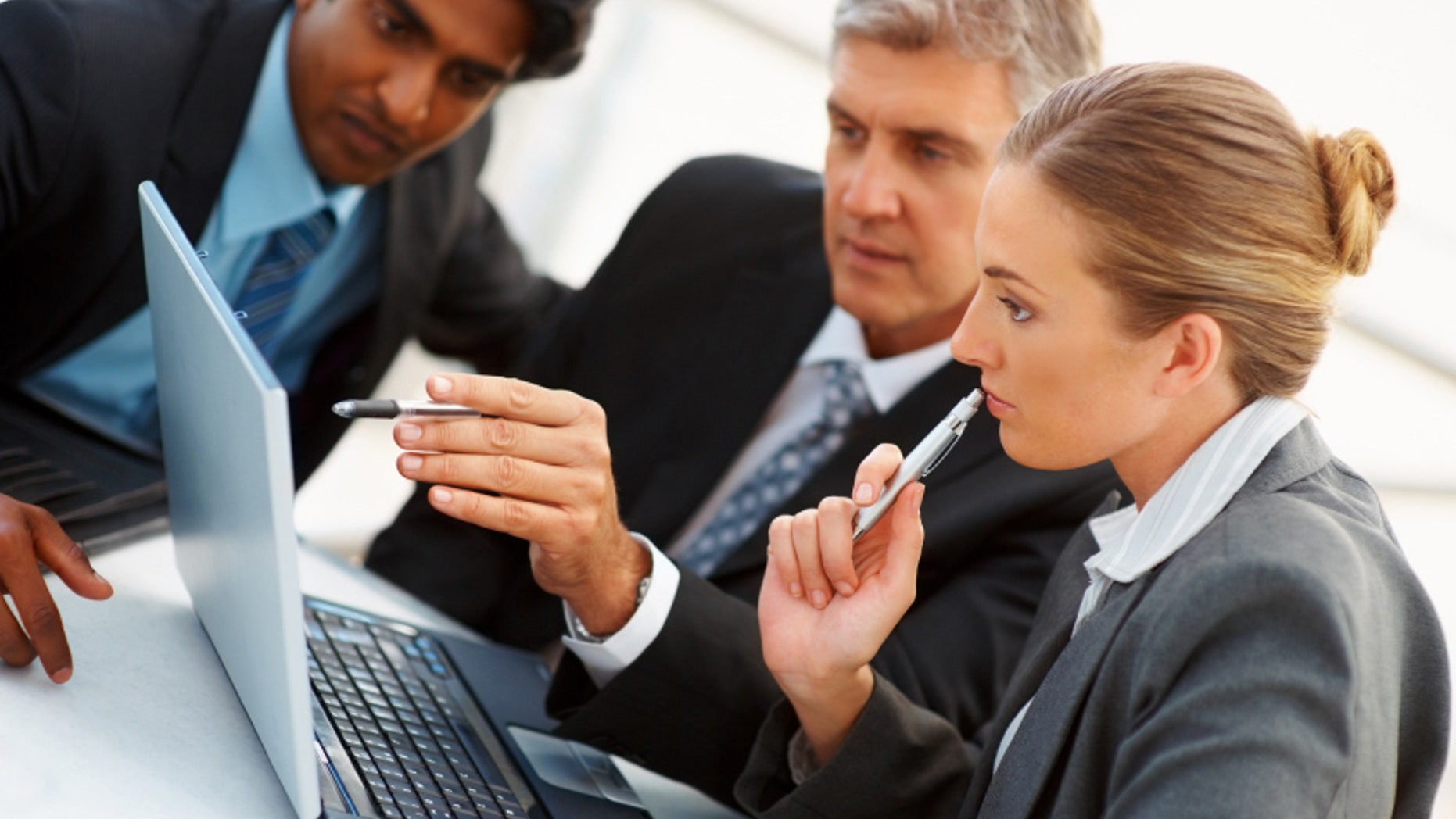 Team of business people working together on a laptop