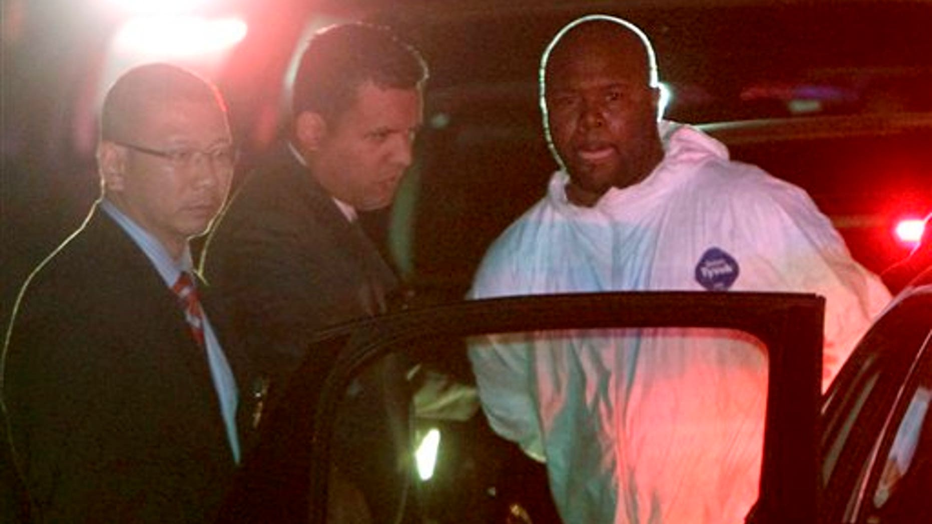 Dec. 13: Lamont Pride is escorted from the 75th Precinct in Brooklyn on Tuesday. Pride's alleged involvement in the Murder of NYPD officer Peter Figoski has raised questions about the court system after he was released by a Judge despite an outstanding warrant from another state a mere week before the tragic shooting.