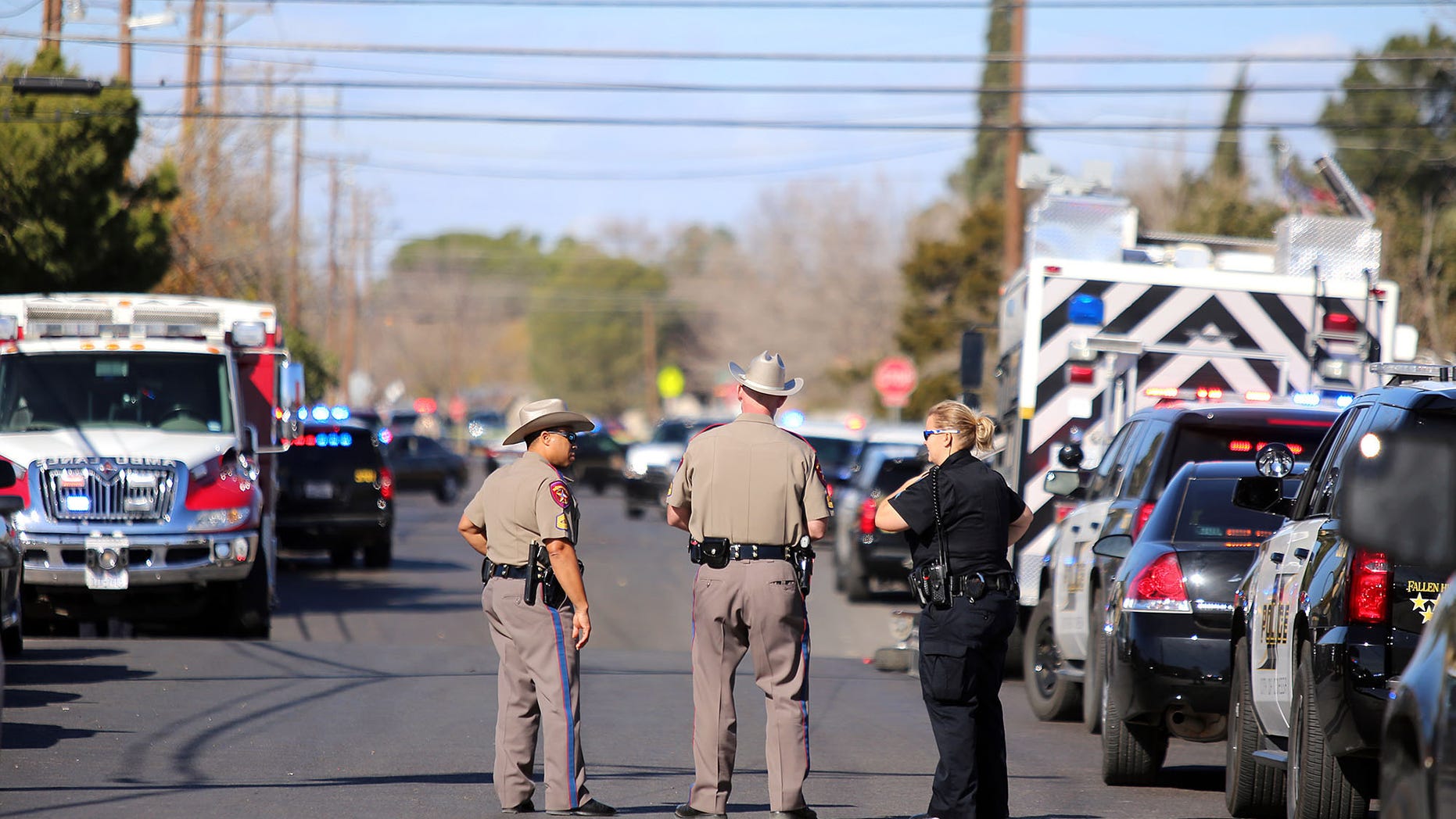 Authorities wait near an apartment complex with a barricaded suspect on Wednesday Dec. 23, 2015, in Odessa, Texas. Authorities say multiple Odessa police officers have been shot while attempting to serve a warrant at the apartment complex, with the suspect barricaded inside. (Edyta Blaszczyk/Odessa American via AP) MANDATORY CREDIT