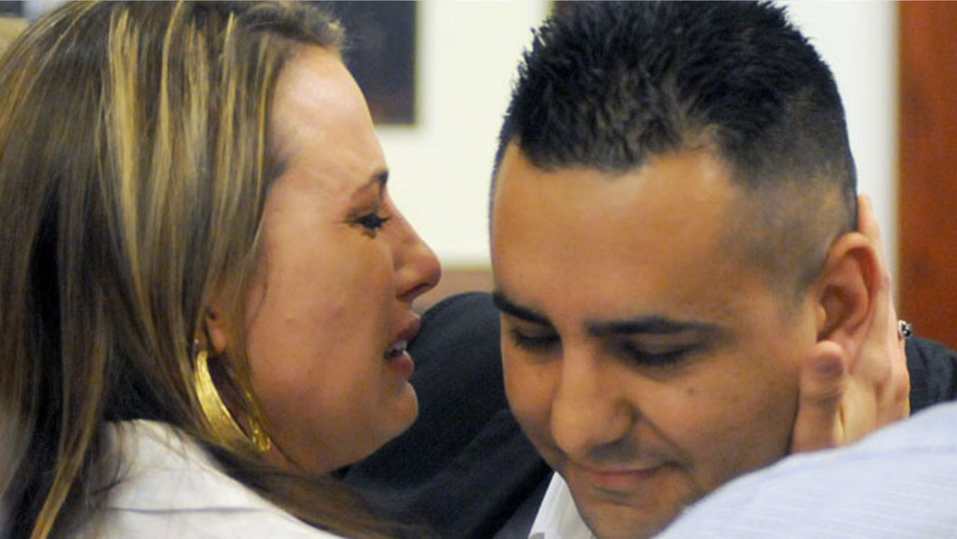 July 16, 2013: Levi Chavez, right, a former Albuquerque police officer, gets a hug from his wife, Heather Chavez, after being cleared of charges he murdered his estranged wife, Tera Chavez, in in 2007. (AP Photo/Albuquerque Journal, Adolphe Pierre-Louis)