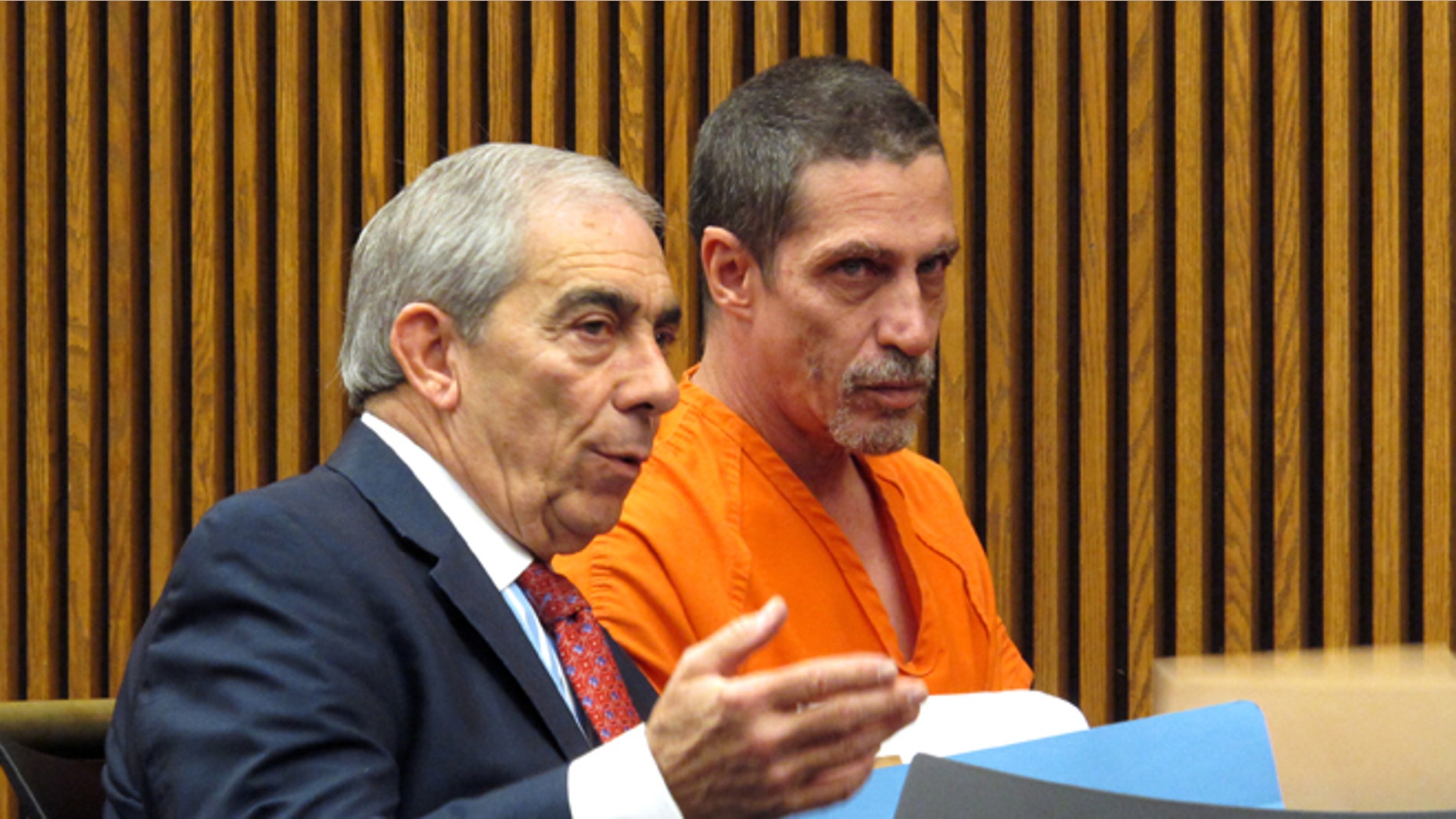 Bobby Hernandez, right, listens to defense attorney Ralph DeFranco in Cuyahoga County Common Pleas Court before pleading not guilty to kidnapping and other charges on Tuesday, Dec. 1, 2015 in Cleveland. Authorities allege Hernandez took his 5-year-old son from an Alabama home in 2002 and created a life for them in Ohio under new identities, a ruse discovered through discrepancies with the boy's Social Security number as he began the college application process. (AP Photo/Kantele Franko)
