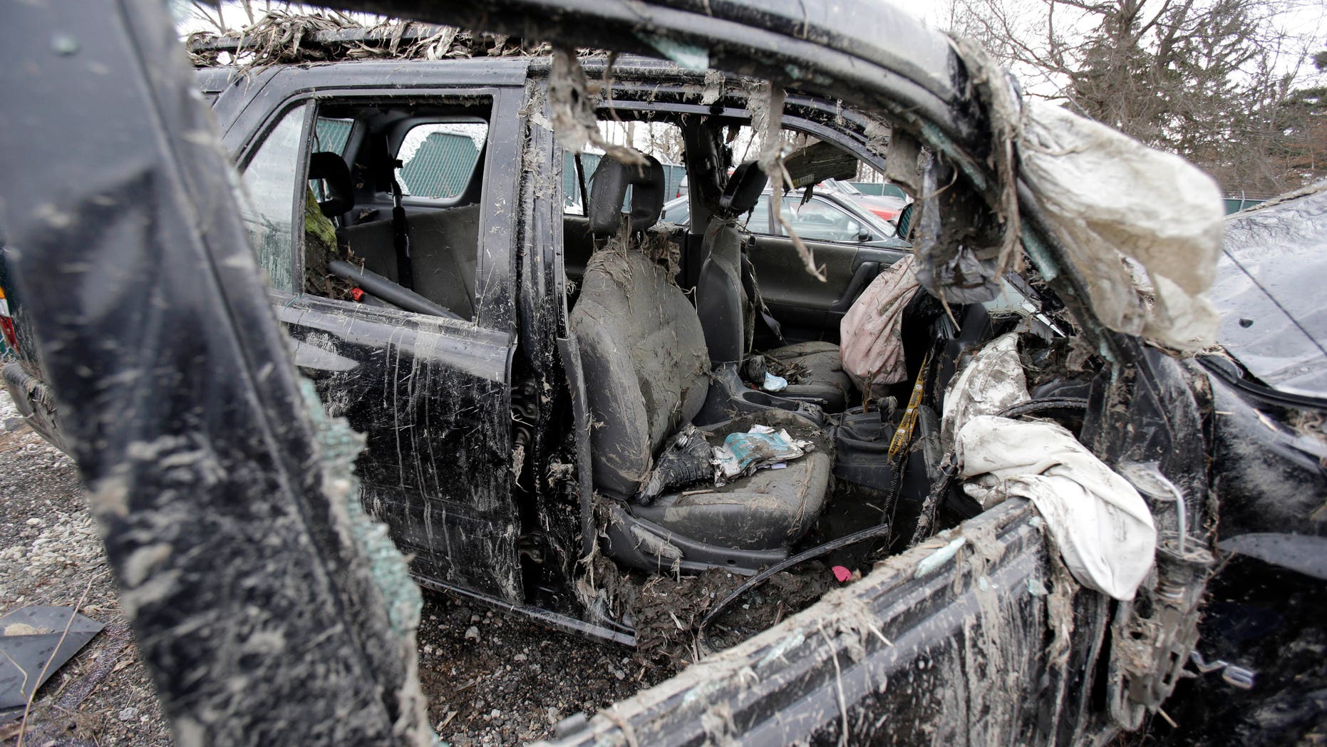 March 11, 2013: Photo in Southington, Ohio shows the vehicle where six people died in a crash early Sunday in Warren, Ohio. Two teens who escaped the crash that killed six friends in a swampy pond wriggled out of the wreckage by smashing a rear window and swimming away from the SUV, a state trooper said Monday.