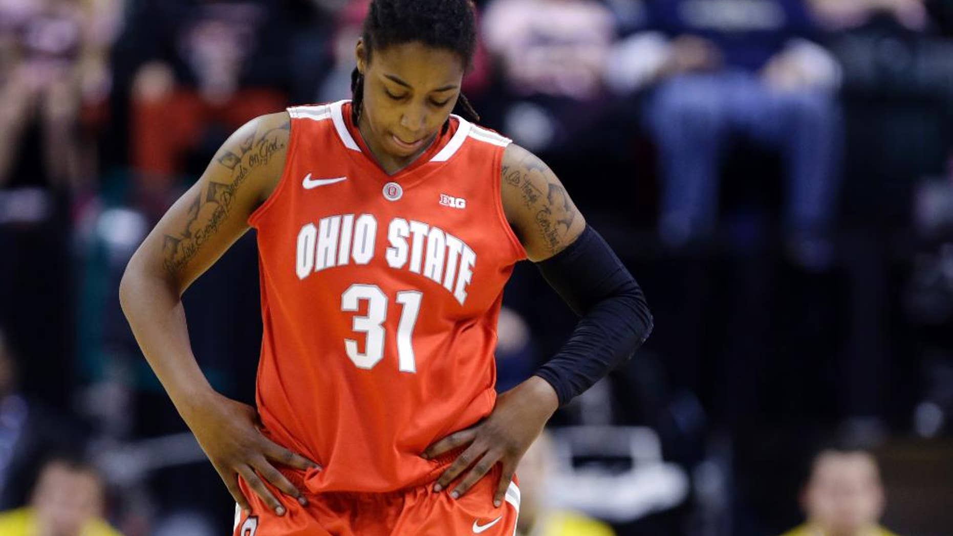 FILE - In this March 8, 2014, file photo, Ohio State guard Raven Ferguson leaves the games after fouling out in the second half of an NCAA college basketball game against the Iowa in the semifinals of the Big Ten women's tournament in Indianapolis. Second-year Ohio State coach Kevin McGuff has dismissed second-leading scorer Raven Ferguson from the team, citing a violation of team rules. McGuff said he would address the dismissal at the team's media day later on Thursday, Oct. 2, 2014. (AP Photo/Michael Conroy, File)