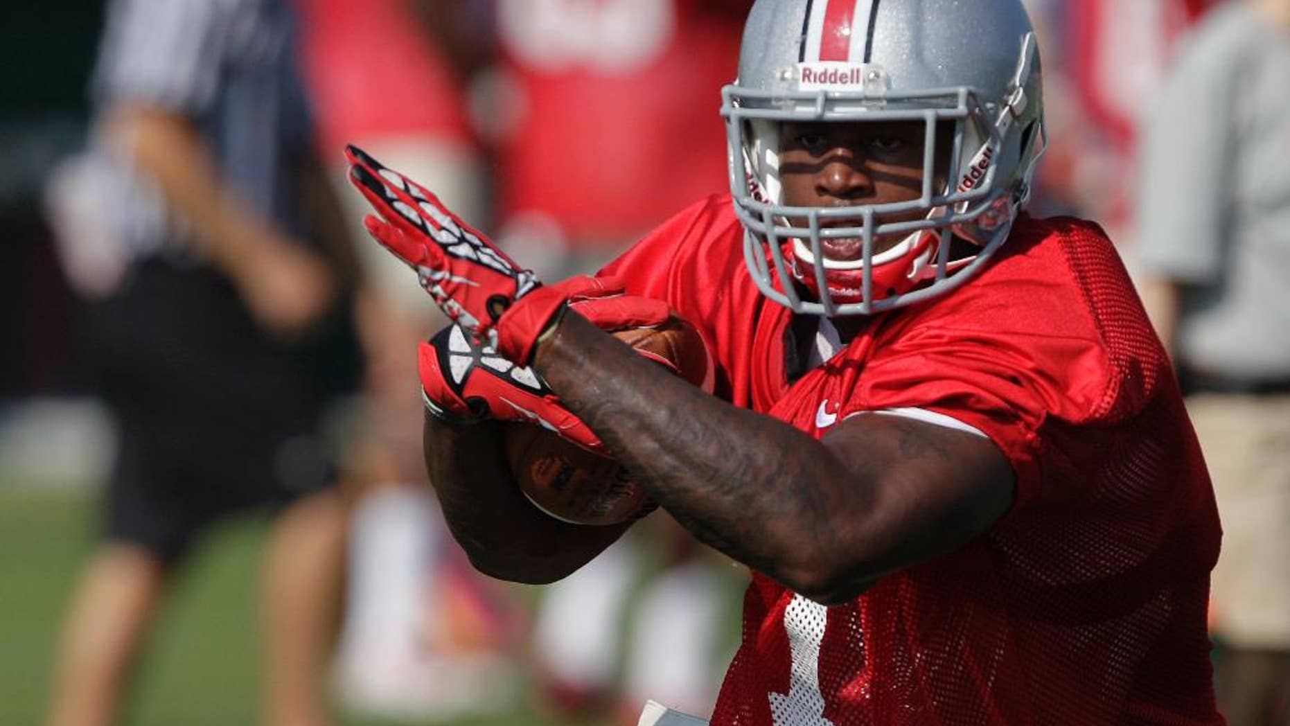 FILE - In this Aug. 9, 2014, file photo, Ohio State running back Rod Smith carries the ball during an NCAA college football practice in Columbus, Ohio. Rod Smith has left the Ohio State team to “deal with some personal issues.” Head coach Urban Meyer confirmed the speculated move on Tuesday, Oct. 28, 2014, in an email.(AP Photo/Jay LaPrete, File)