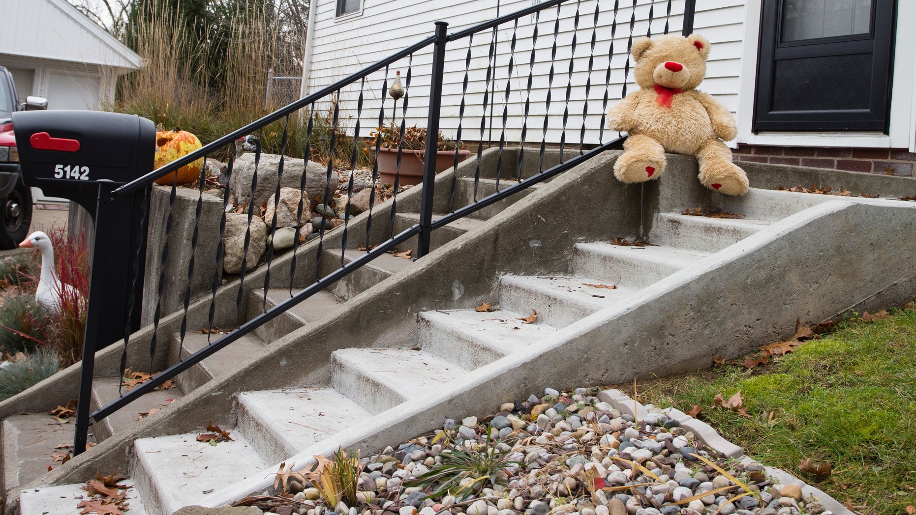 Nov. 13, 2012: A lone teddy bear sits on the steps of the home where three children, their uncle, and their grandmother were found dead inside a garage Monday in what appears to be a murder-suicide amid a custody dispute in Toledo, Ohio.
