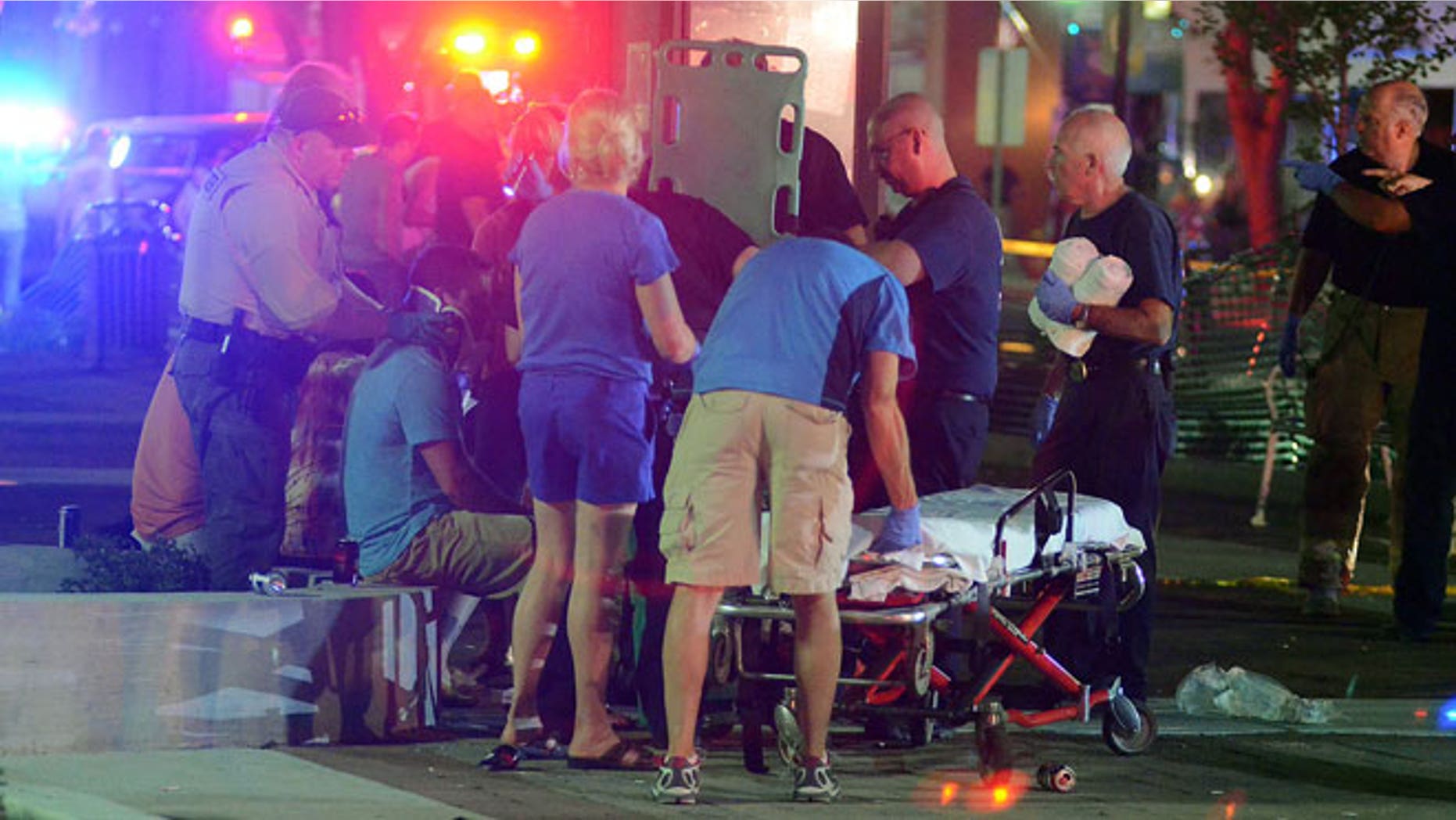 June 15, 2012: Emergency workers treat injured bystanders after a motorist drove into the Rally n Lima’s Town Square in Lima, Ohio.