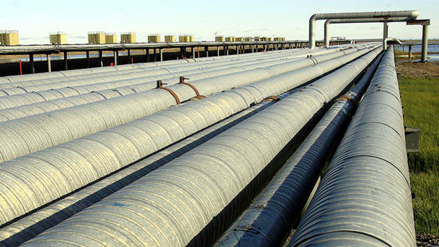 Oil transit and other pipelines run along a row of oil pump houses at the Prudhoe Bay oil field on Alaska's North Slope Friday, Aug. 4, 2006. BP Exploration Alaska, Inc. began shutting down the Prudhoe Bay oil field Sunday after the discovery of unexpectedly severe corrosion and a small spill from a Prudhoe Bay oil transit line. (AP Photo/Al Grillo)