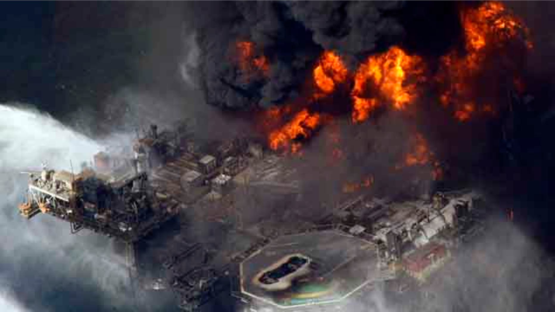 FILE - In this April 21, 2010 file aerial photo taken in the Gulf of Mexico more than 50 miles southeast of Venice on Louisiana's tip, the Deepwater Horizon oil rig is seen burning. (AP Photo/Gerald Herbert, File)