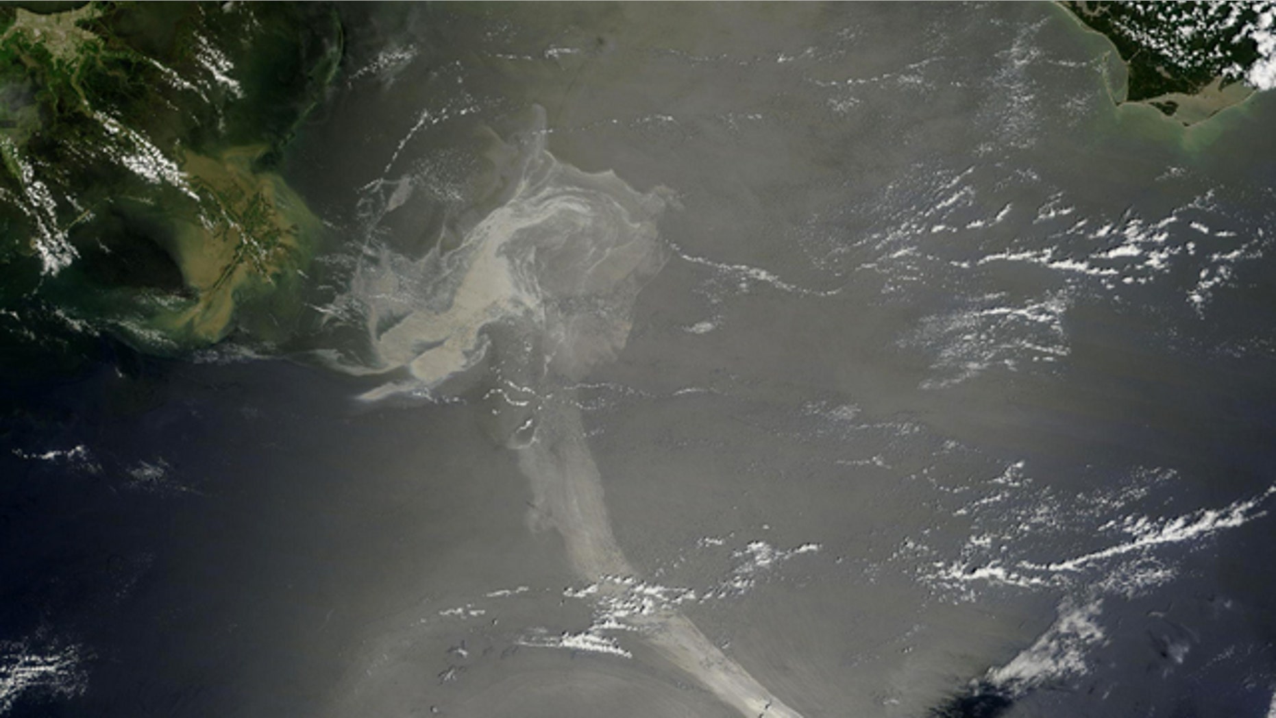 FILE: NASA's Terra satellite captured the Gulf oil spill on May 17. In this image, the oil slick appears as a dull gray on the water's surface and stretches south from the Mississippi Delta with what looks like a tail.
