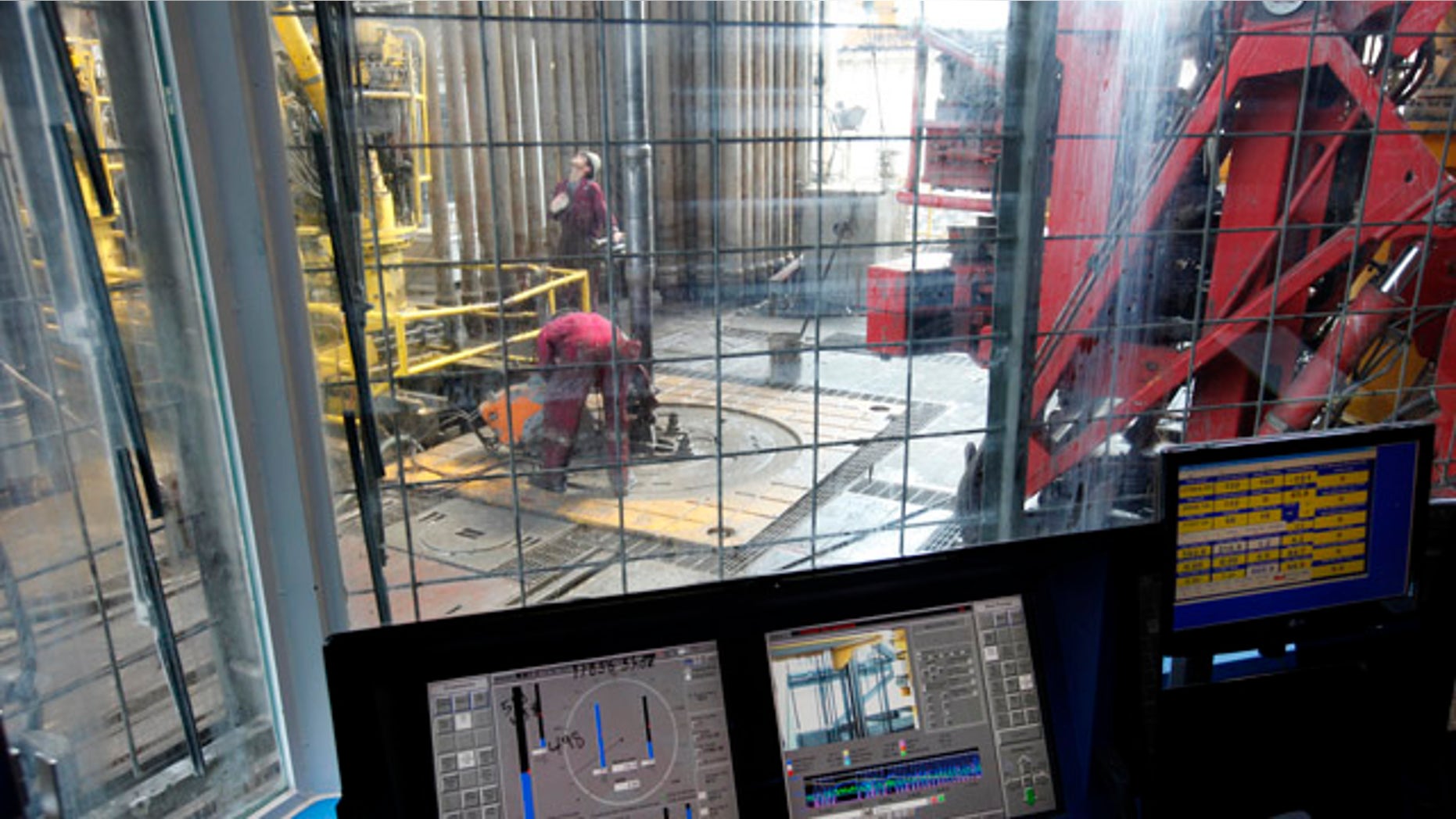 Sept. 18: Workers on the drilling floor are seen on from the window of the drilling cage as the drilling pipe is removed on the Development Driller III which drilled the relief well and pumped cement to seal the Macondo well.