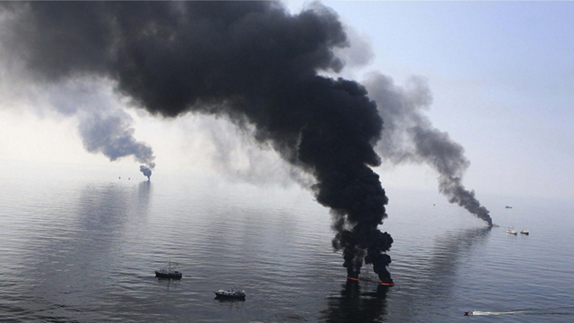 FILE June 2010: Smoke billows from a controlled burn of spilled oil off the Louisiana coast.