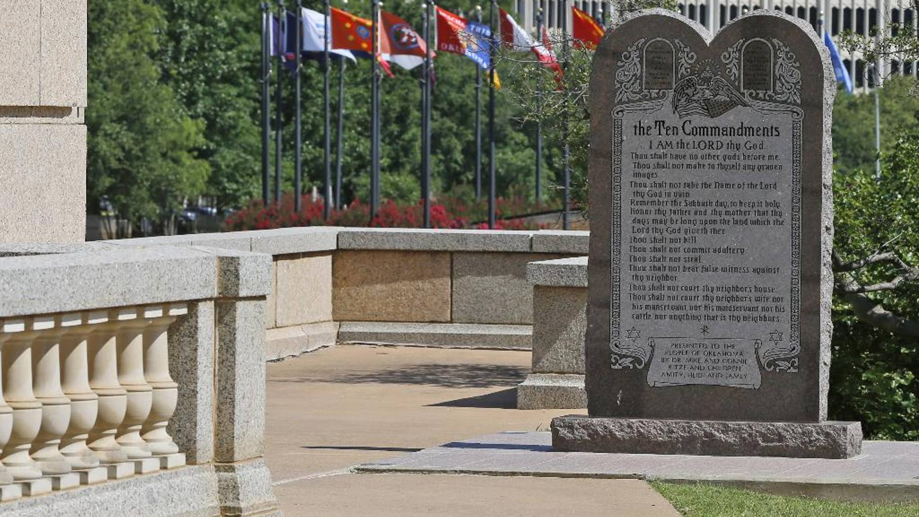 The Ten Commandments monument is pictured at the state Capitol in Oklahoma City, Tuesday, June 30, 2015. Oklahoma’s Supreme Court says the monument must be removed because it indirectly benefits the Jewish and Christian faiths in violation of the state constitution. (AP Photo/Sue Ogrocki)
