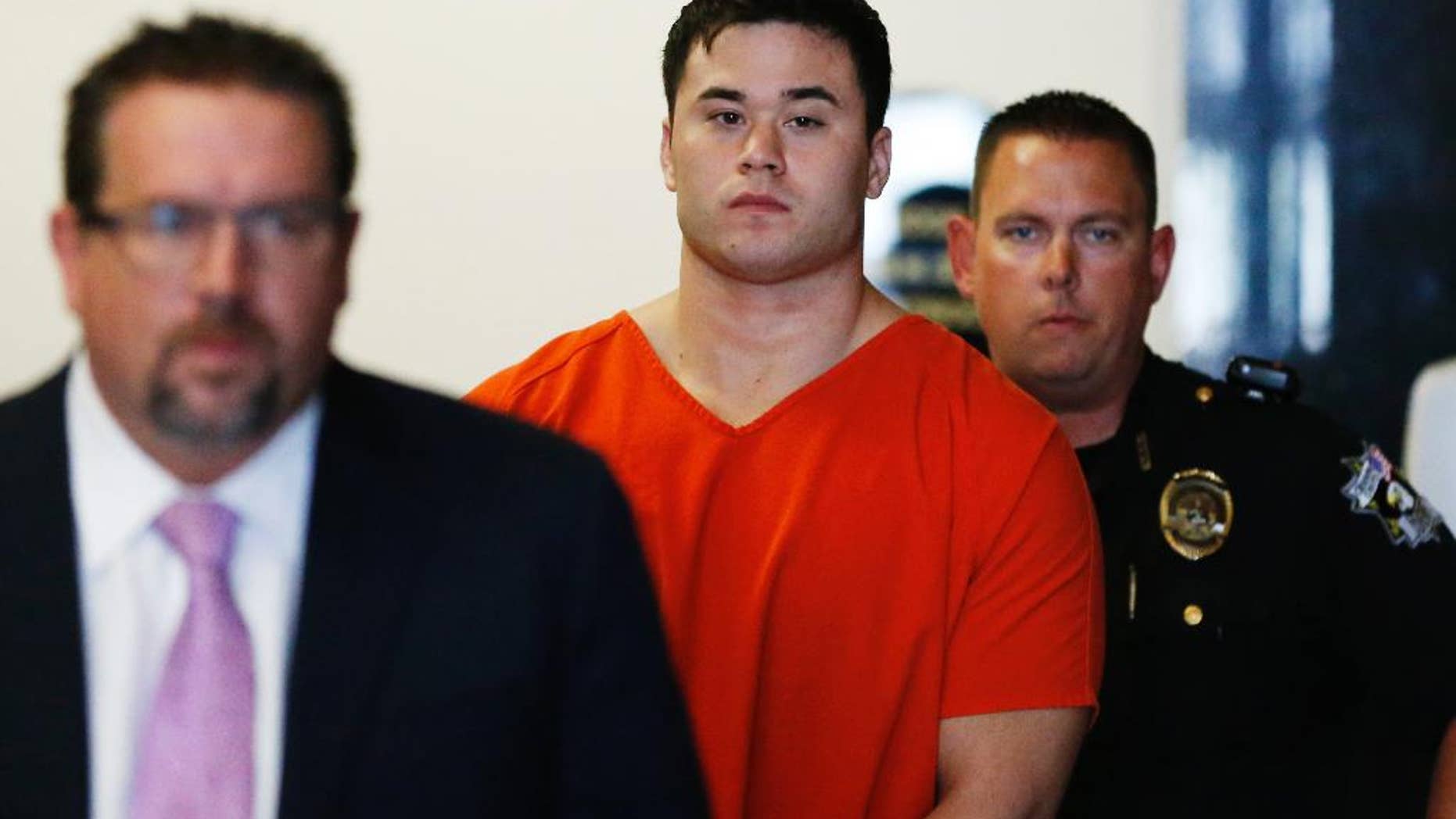 FILE - In this Sept. 3, 2014, file photo Daniel Holtzclaw, center, arrives for a hearing in Oklahoma City. Holtzclaw, an Oklahoma City police officer, is accused of sexually assaulting 13 women while on patrol. (AP Photo/Sue Ogrocki, File)