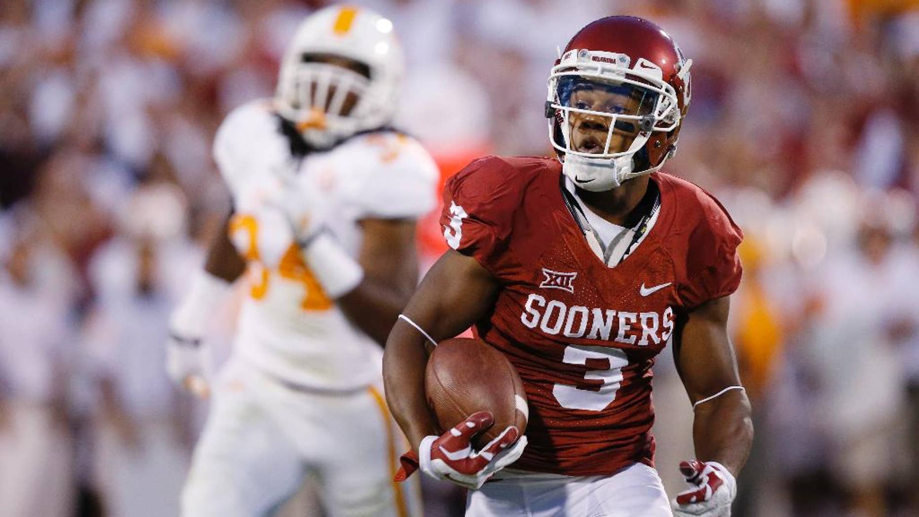 FILE - In this Sept. 13, 2014, file photo, Oklahoma wide receiver Sterling Shepard (3) carries during an NCAA college football game against Tennessee in Norman, Okla. With all the hype about freshman running back Samaje Perine, Sterling Shepard was an afterthought during Oklahoma's win over West Virginia. The junior has been the Sooners' most consistent offensive player, and he's coming off his third game with at least 100 yards receiving. (AP Photo/Sue Ogrocki, File)