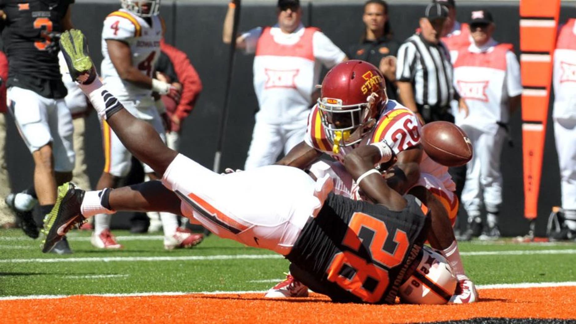 Oct 4, 2014; Stillwater, OK, USA; Oklahoma State Cowboys wide receiver James Washington (28) looses the ball at the goal line as Iowa State Cyclones defensive back Qujuan Floyd (26) defends during the second half at Boone Pickens Stadium. Oklahoma won 37-20. Mandatory Credit: Denny Medley-USA TODAY Sports