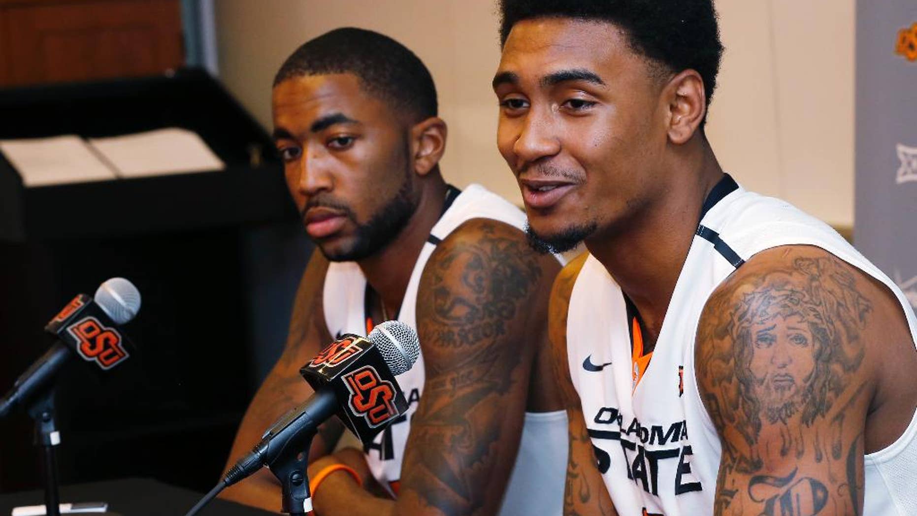 Oklahoma State post Michael Cobbins, left, and wing Le'Bryan Nash, right, answer questions during an NCAA college basketball media day in Stillwater, Okla., Monday, Oct. 20, 2014. (AP Photo/Sue Ogrocki)