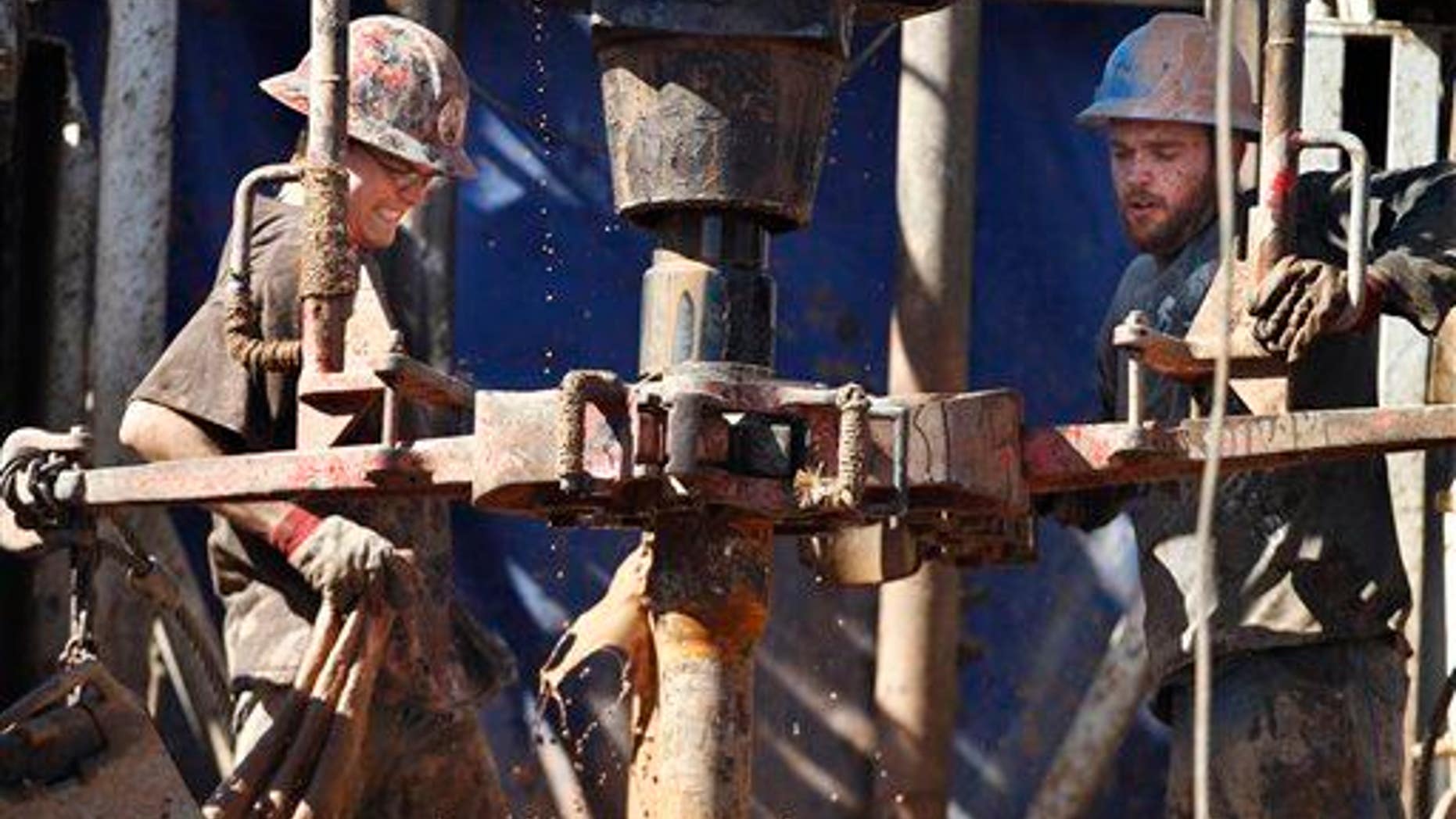 In this Tuesday, Feb. 21, 2012 photo, oil field workers drill into the Gypsum Hills near Medicine Lodge, Kan.