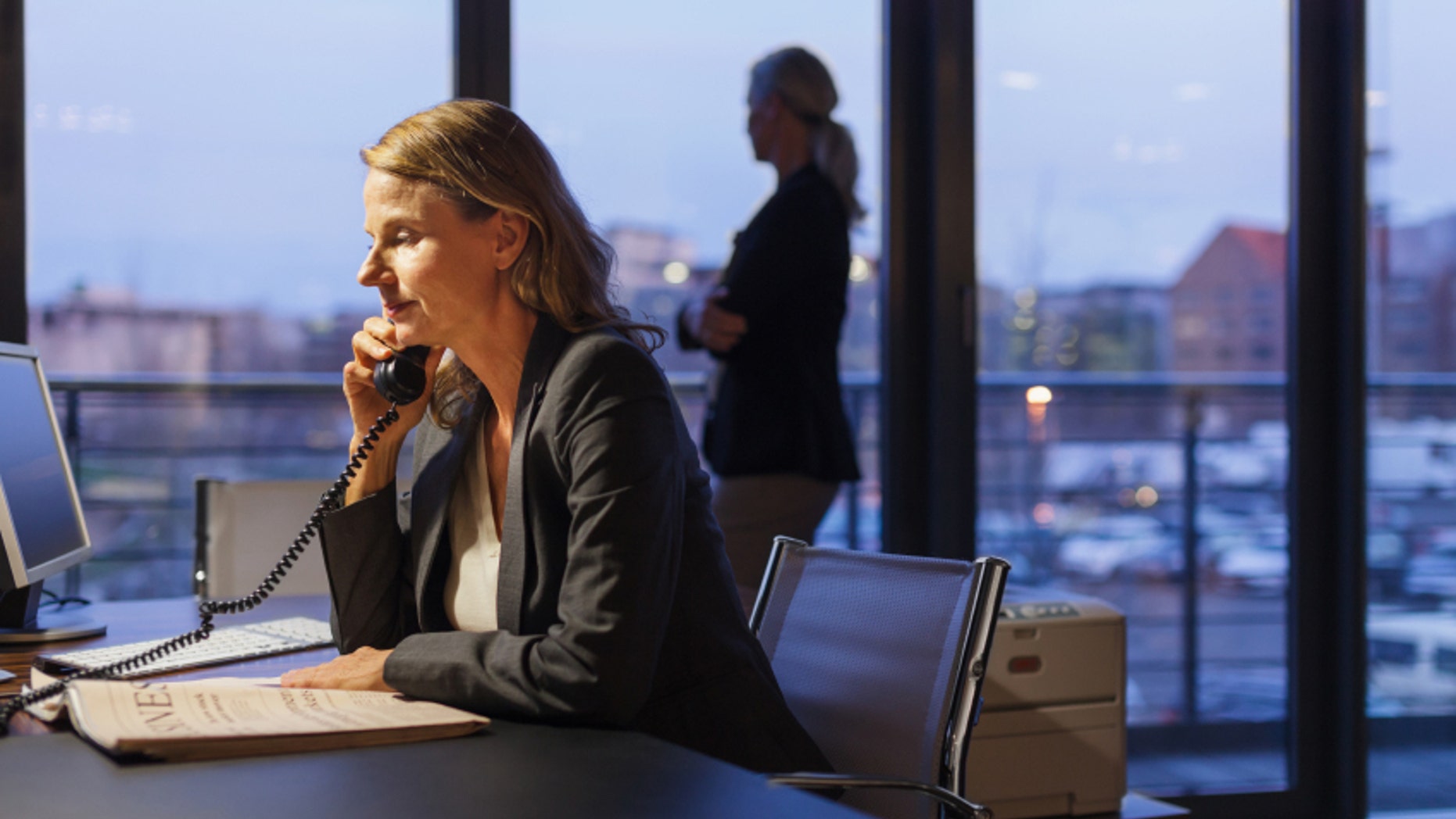 Mature businesswoman working late at her desk.