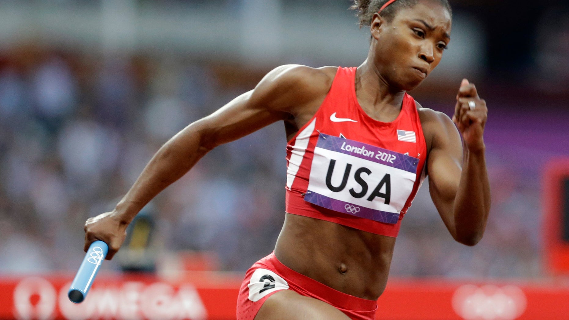 Aug. 9, 2012: In this file photo, United States' Tianna Madison runs in the first leg of the women's 400-meter relay heat at the Summer Olympics in London.