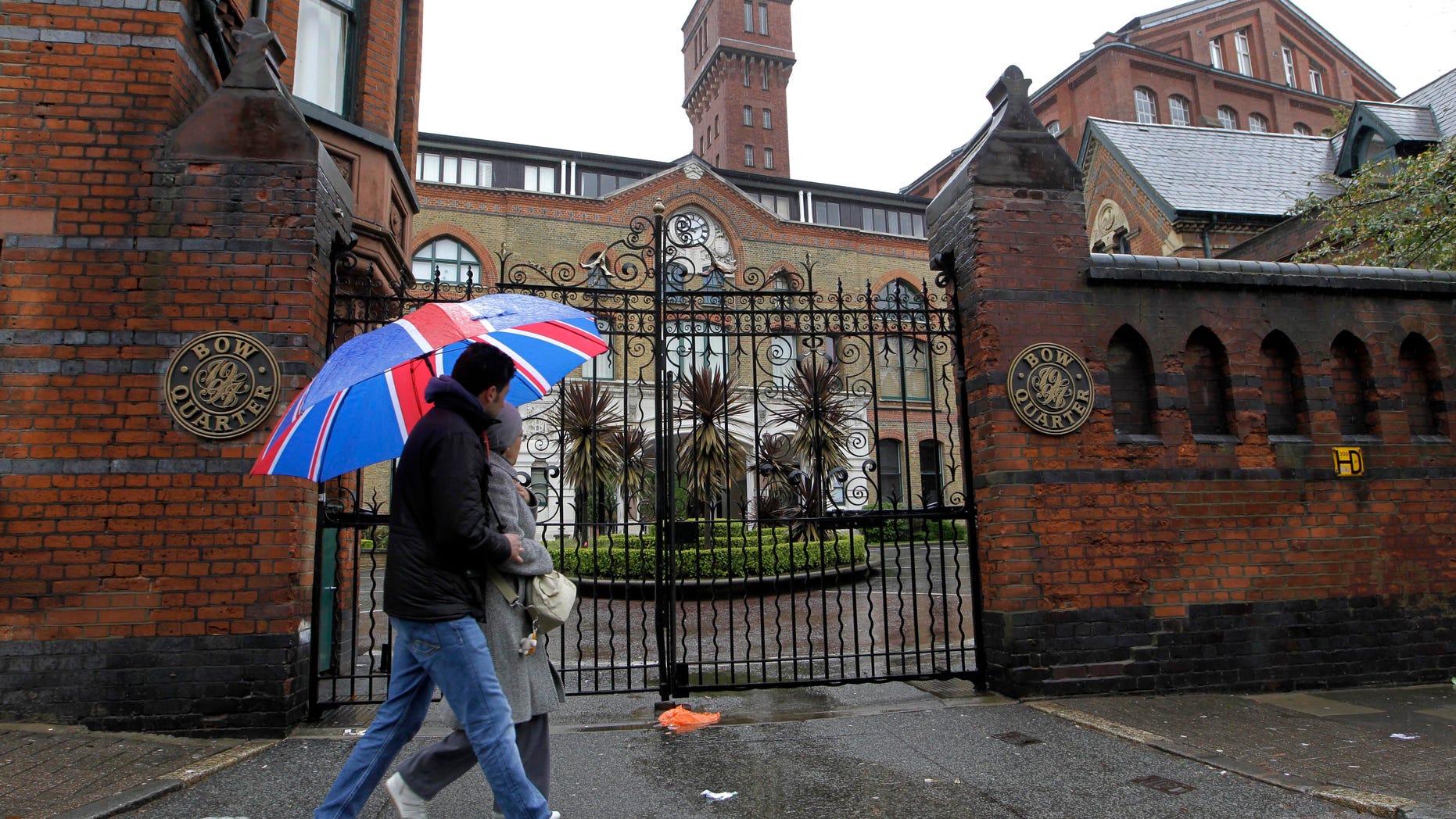 File - In this file photo dated Sunday, April 29, 2012 shows people walk past gated residential flats in Bow, east London, where the Ministry of Defence have warned residents that surface-to-air missiles could be stationed on their rooftops during the London Olympics. The British military plans to deploy surface-to-air missiles at six sites around London as part of security measures for the July 27- Aug. 12 games. The layer of the residents of the 17-story Fred Wigg Tower in Leytonstone, east London, told the High Court on Monday, July 9, 2012 that residents fear the missiles could make the building a terrorist target. (AP Photo/Sang Tan,File)