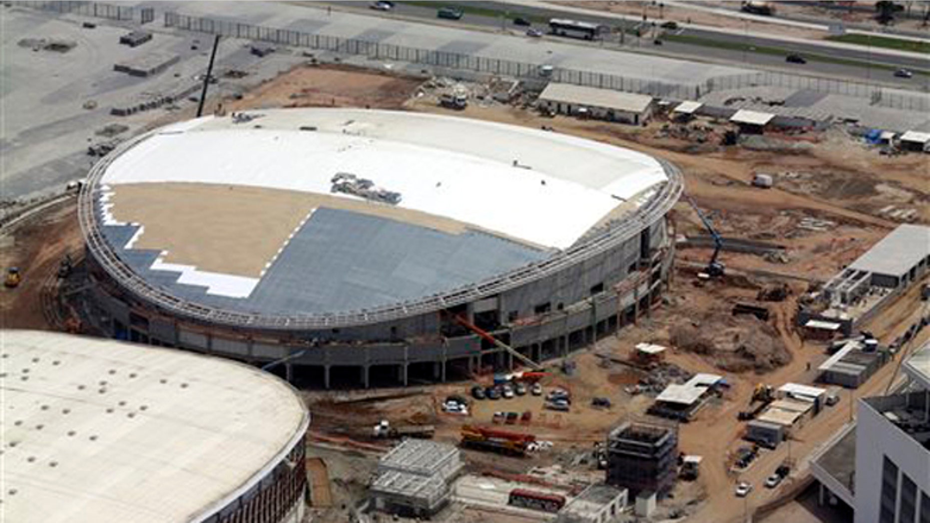 FILE - In this Oct. 9, 2015, file aerial photo, construction continues at the Rio Olympics velodrome in Rio de Janeiro. The president of cyclings world governing body remains very, very concerned that the velodrome under construction for the Rio Olympics will not be completed by the opening in August. (AP Photo/David J. Phillip, File)