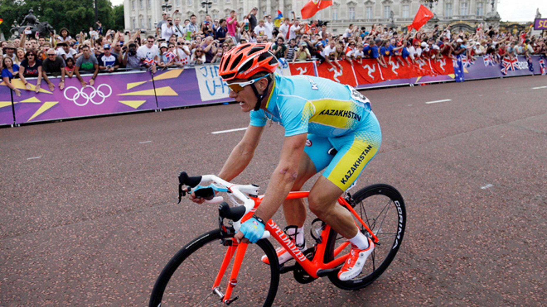 July 28, 2012: Kazakhstan's Alexandr Vinokourov pedals past Buckingham Palace on his way to win the Men's Road Cycling race at the 2012 Summer Olympics in London.