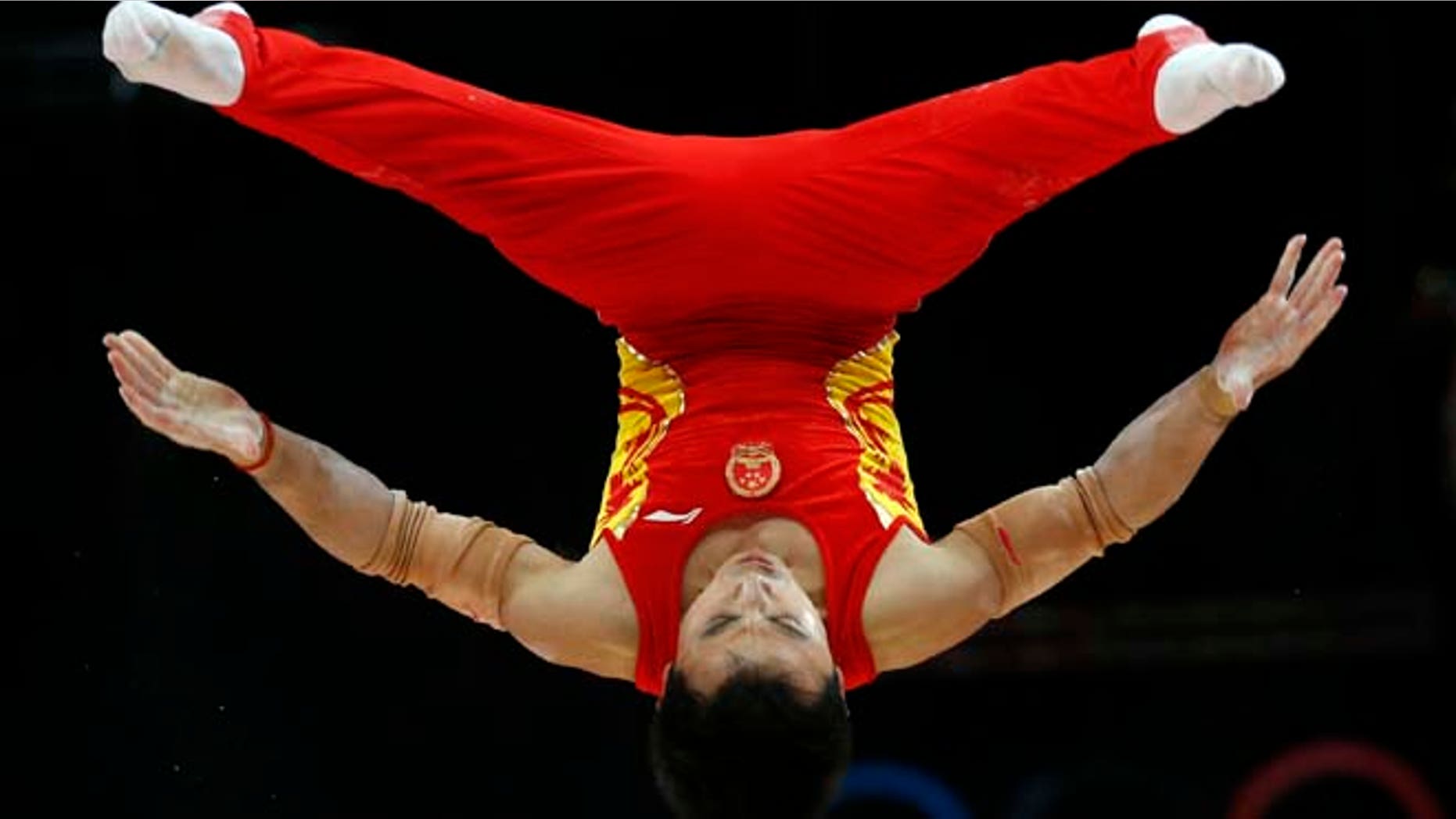 July 30, 2012: Chinese gymnast Feng Zhe performs on the parallel bars during the Artistic Gymnastic men's team final at the 2012 Summer Olympics, in London.